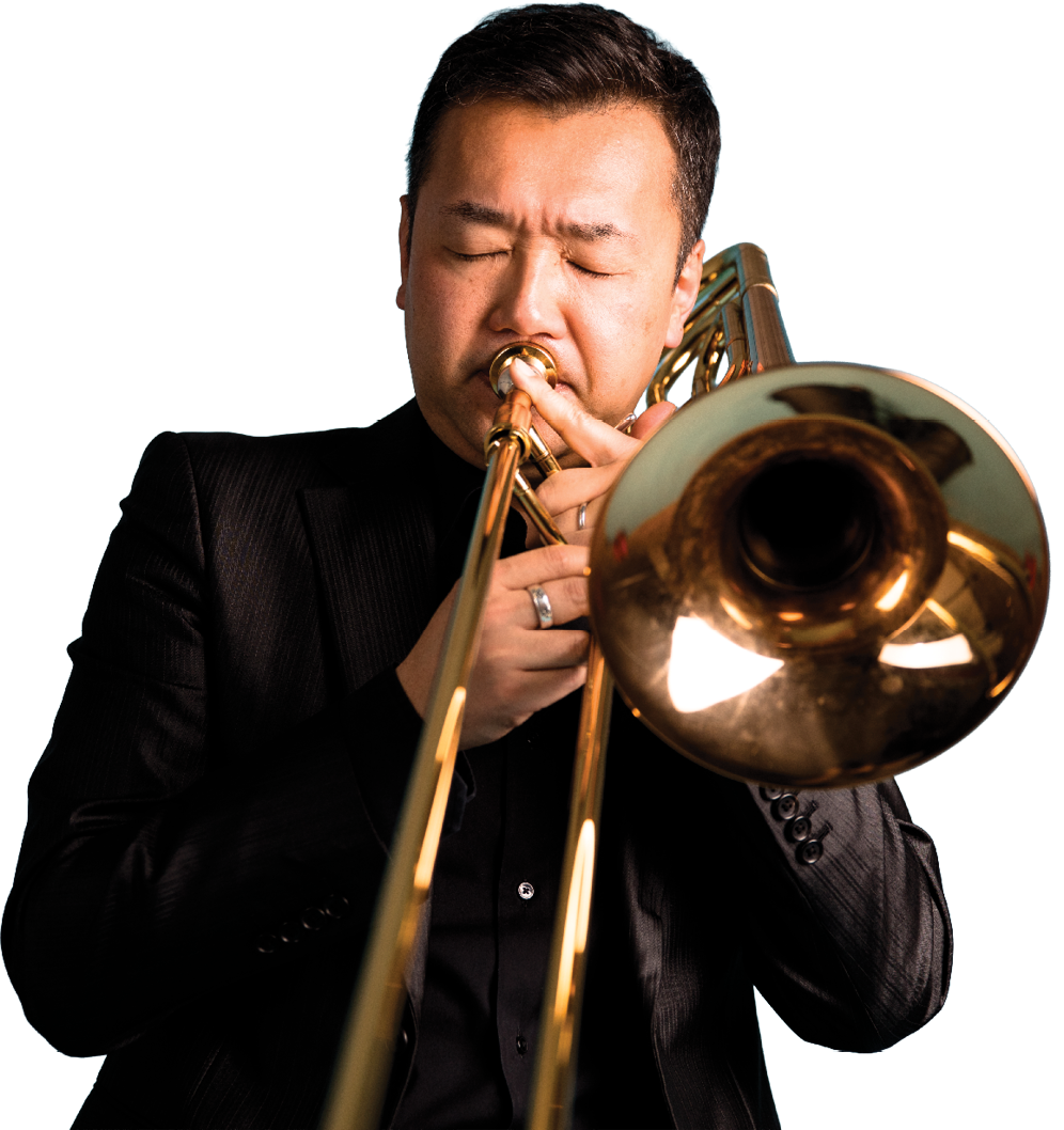 A man in a black suit playing a trumpet with his eyes closed. Eijiro Nakagawa,