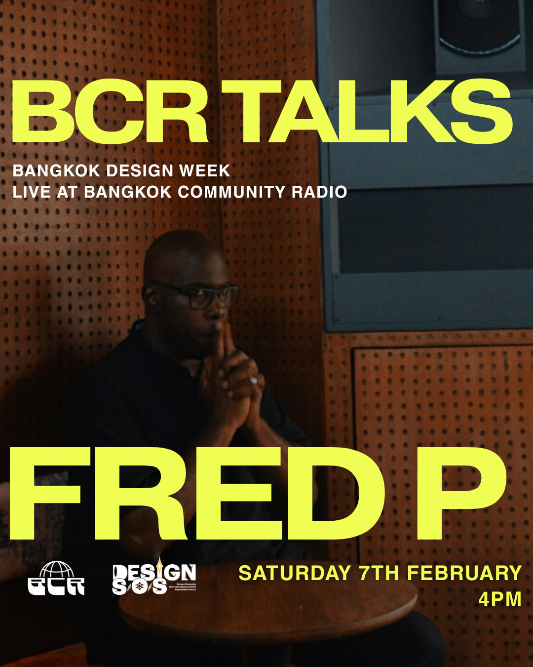 A person with glasses and a black shirt, sitting at a small round table with hands clasped near their face, against a brown perforated wall with black panels, with large yellow text overlay that reads 'BCR TALKS' and 'FRED P', and smaller white text about Bangkok Design Week event details.