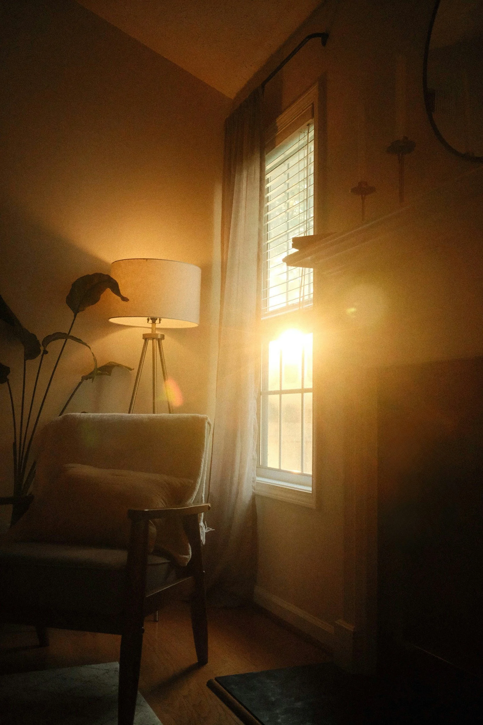 empty cozy corner with chair and throw blanket in soft window light reflecting energy pacing in chronic illness