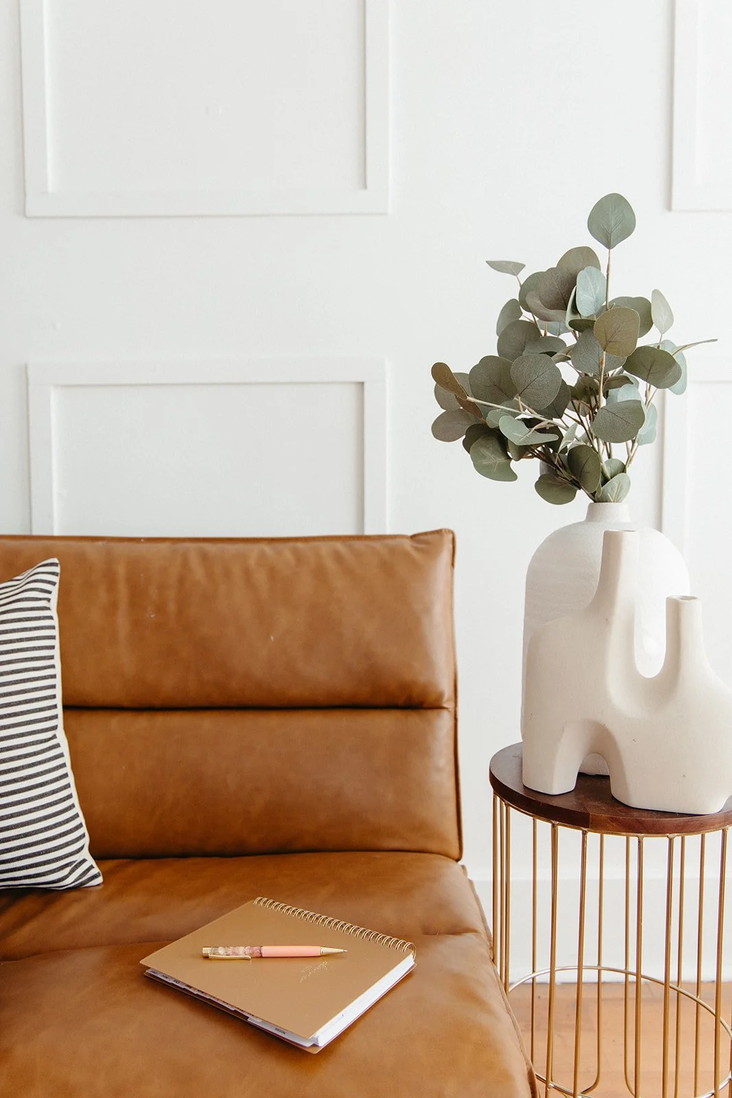 Brown planner resting on a leather couch in a Brea, CA counseling office, providing answers to anxiety therapy FAQs.