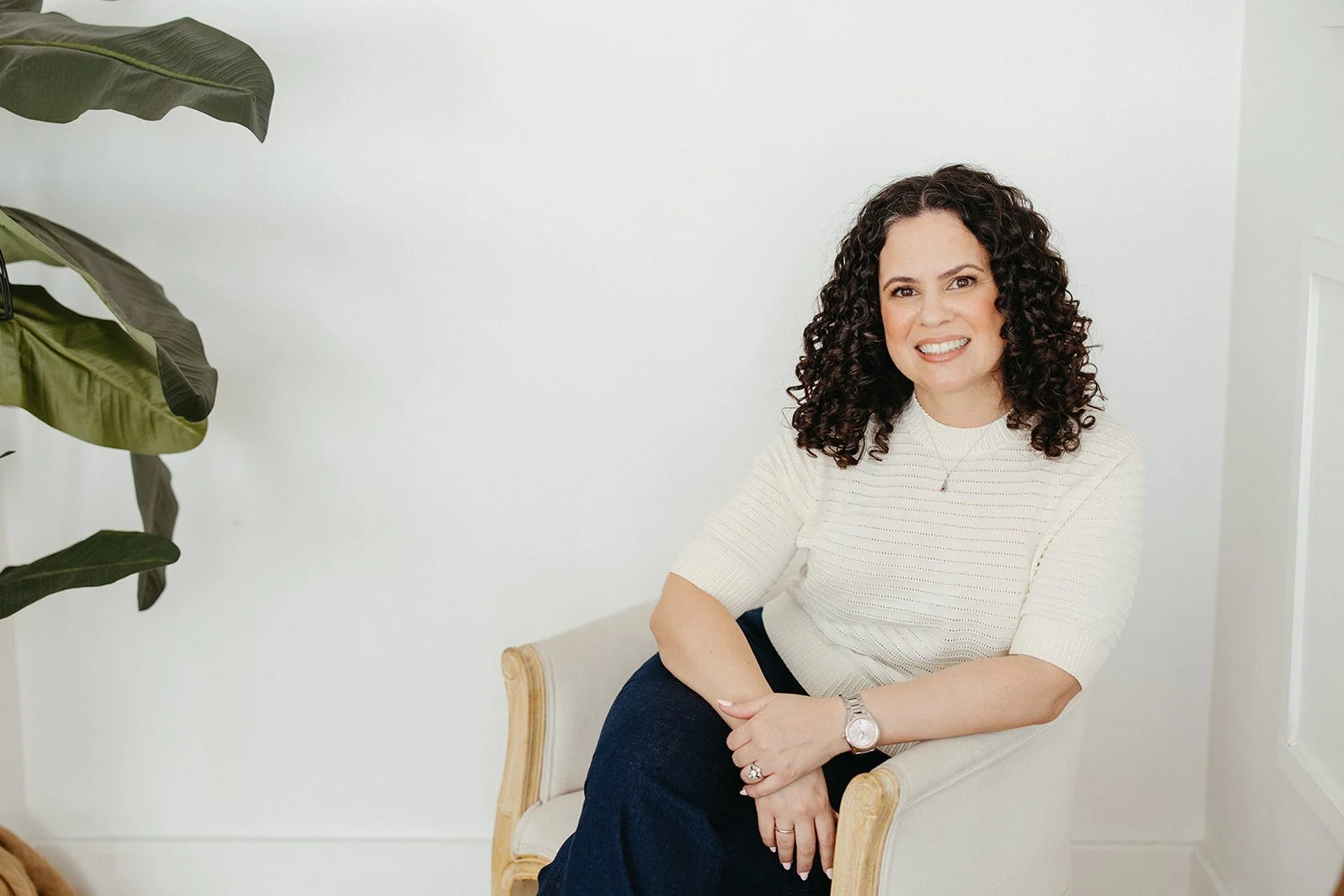 Brea, CA anxiety and burnout therapist Jaclyn Staubach, LCSW, wearing a white shirt and sitting in a white office chair.