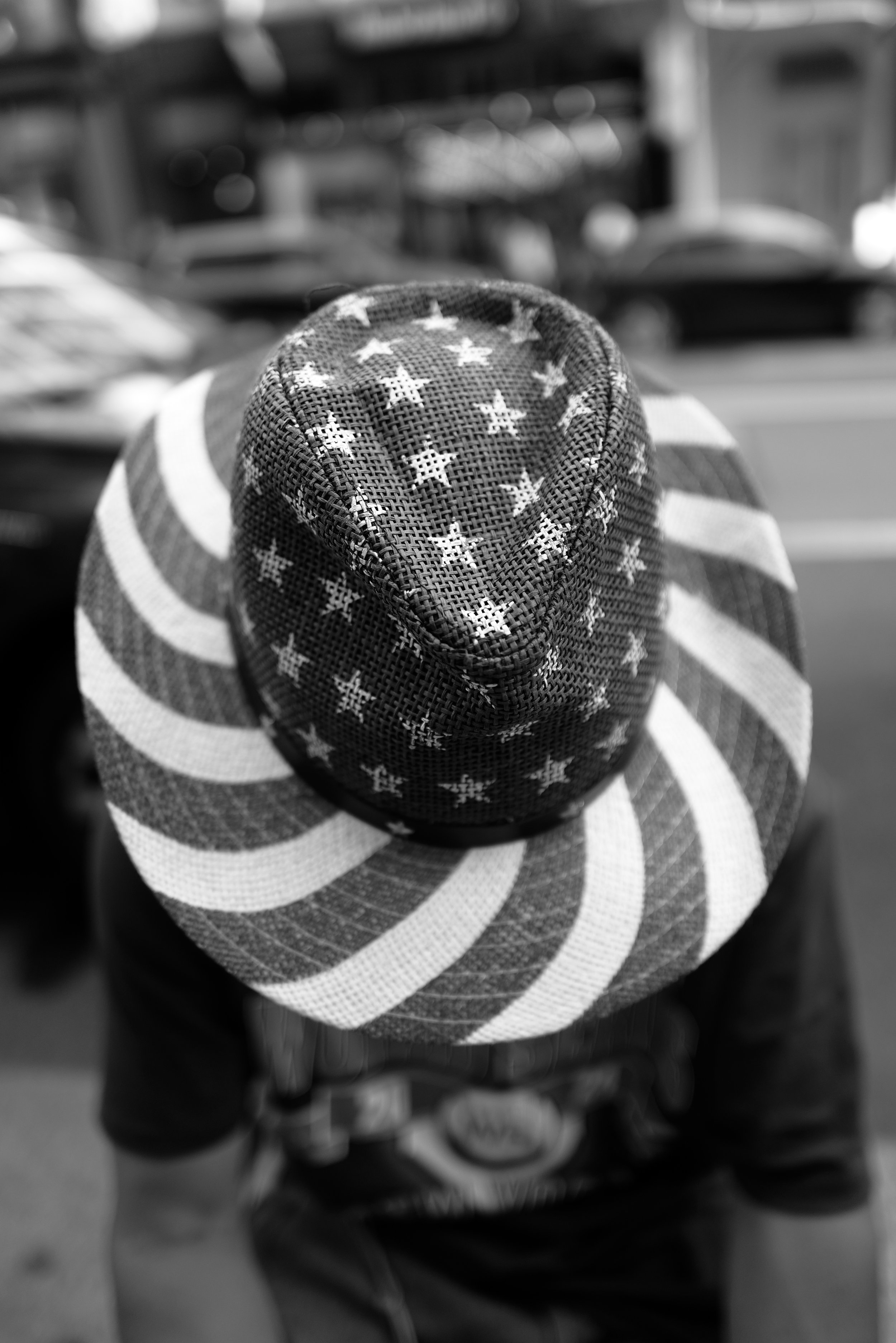 A hat with an American flag design, featuring stars and stripes in a black and white pattern.