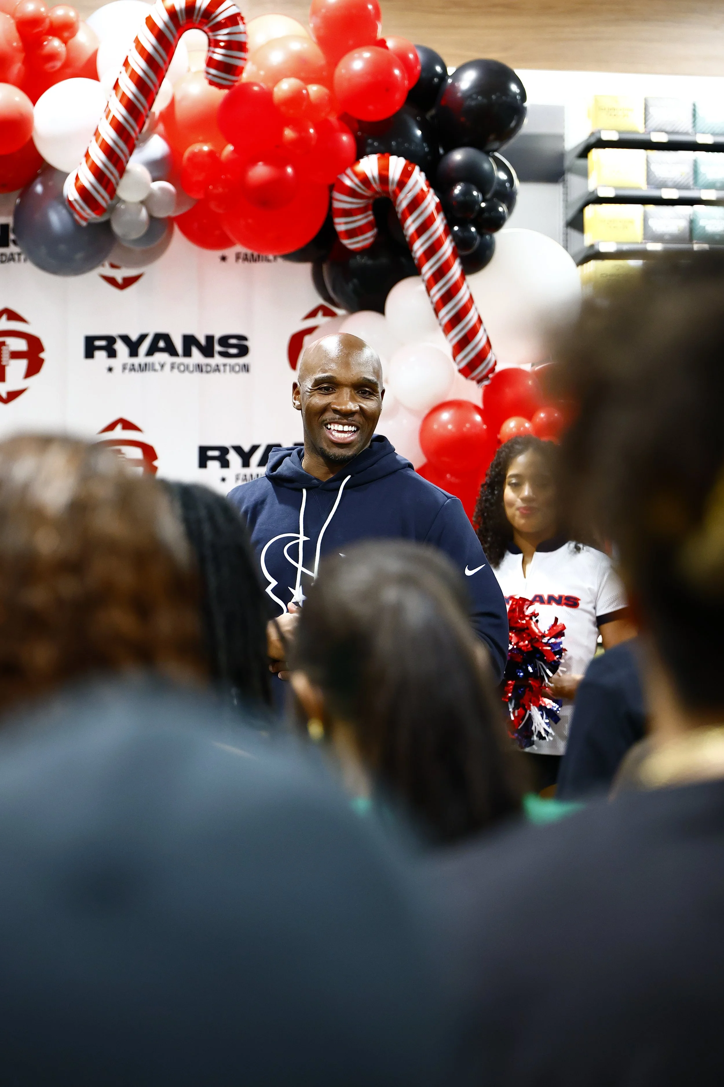 Coach DeMeco Ryans greeting families before the Holiday Shopping Experience.
