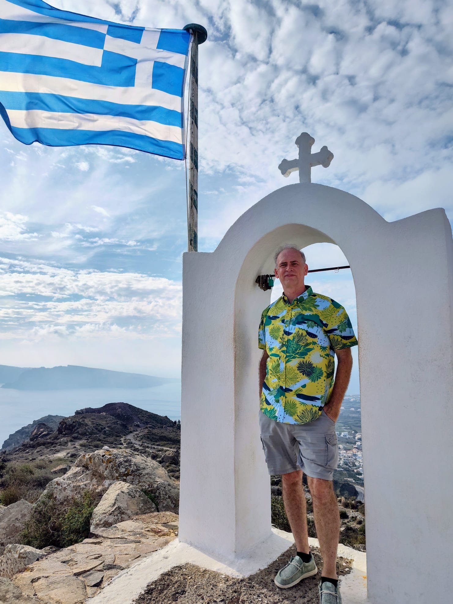 Corey, owner of Sunrise Travel, hiking near a white-washed chapel in Santorini, Greece during a Mediterranean cruise