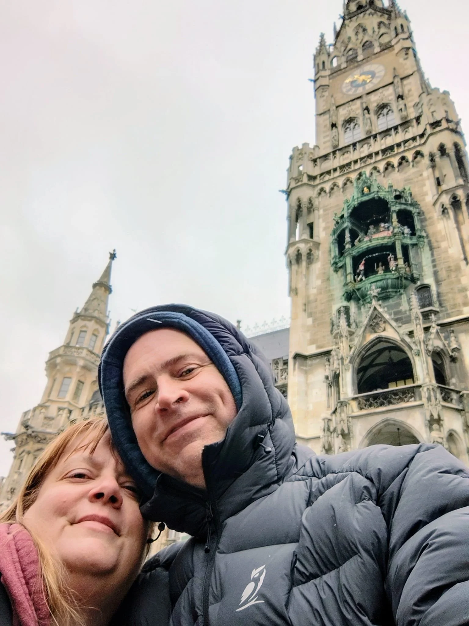 Sunrise Travel hosts Elaine & Corey sharing a smile in front of the Munich Glockenspiel during a hosted European Christmas Market Journey