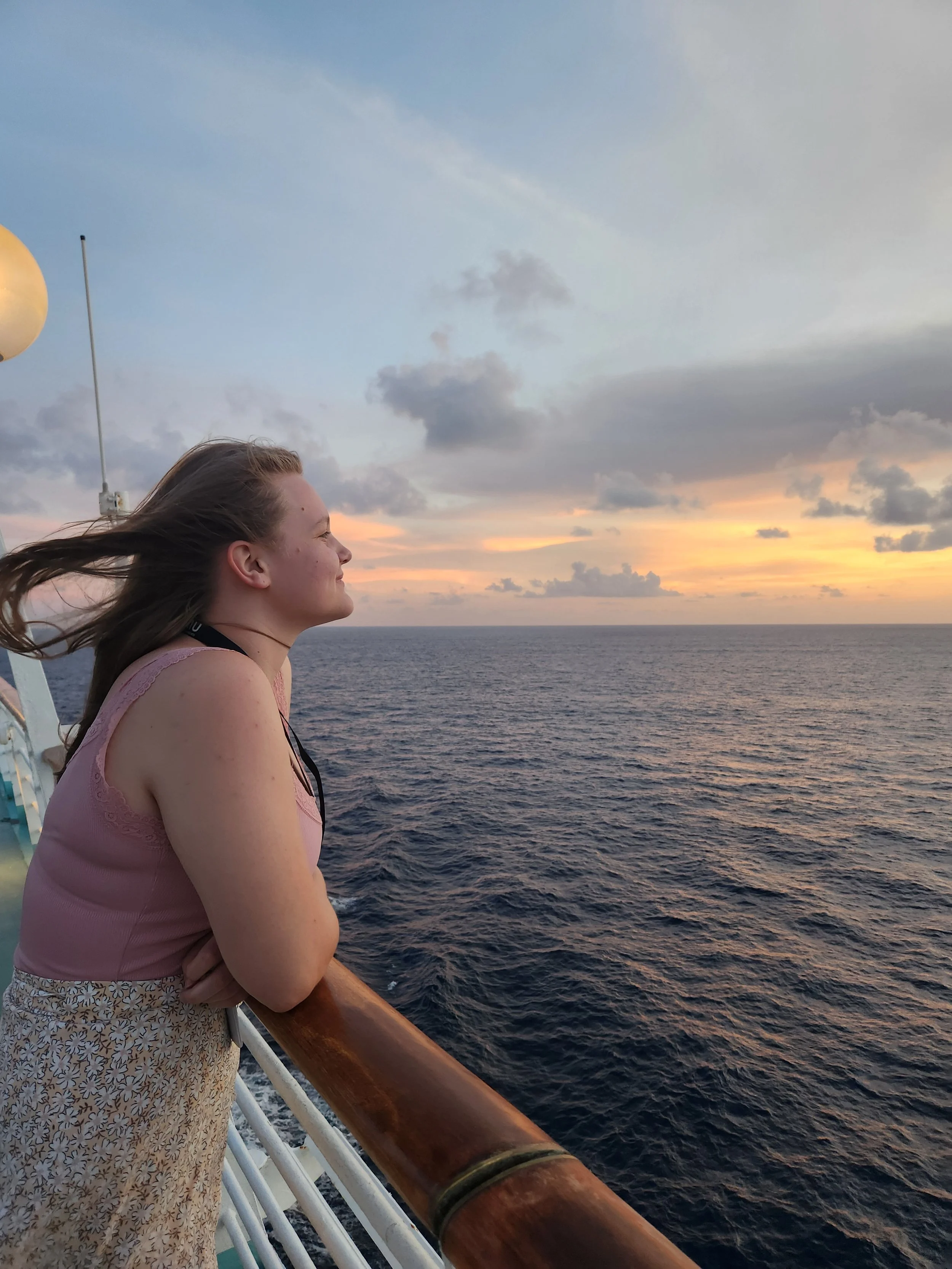 A Sunrise Travel expert experiencing a sunset at sea during a Royal Carribbean voyage.