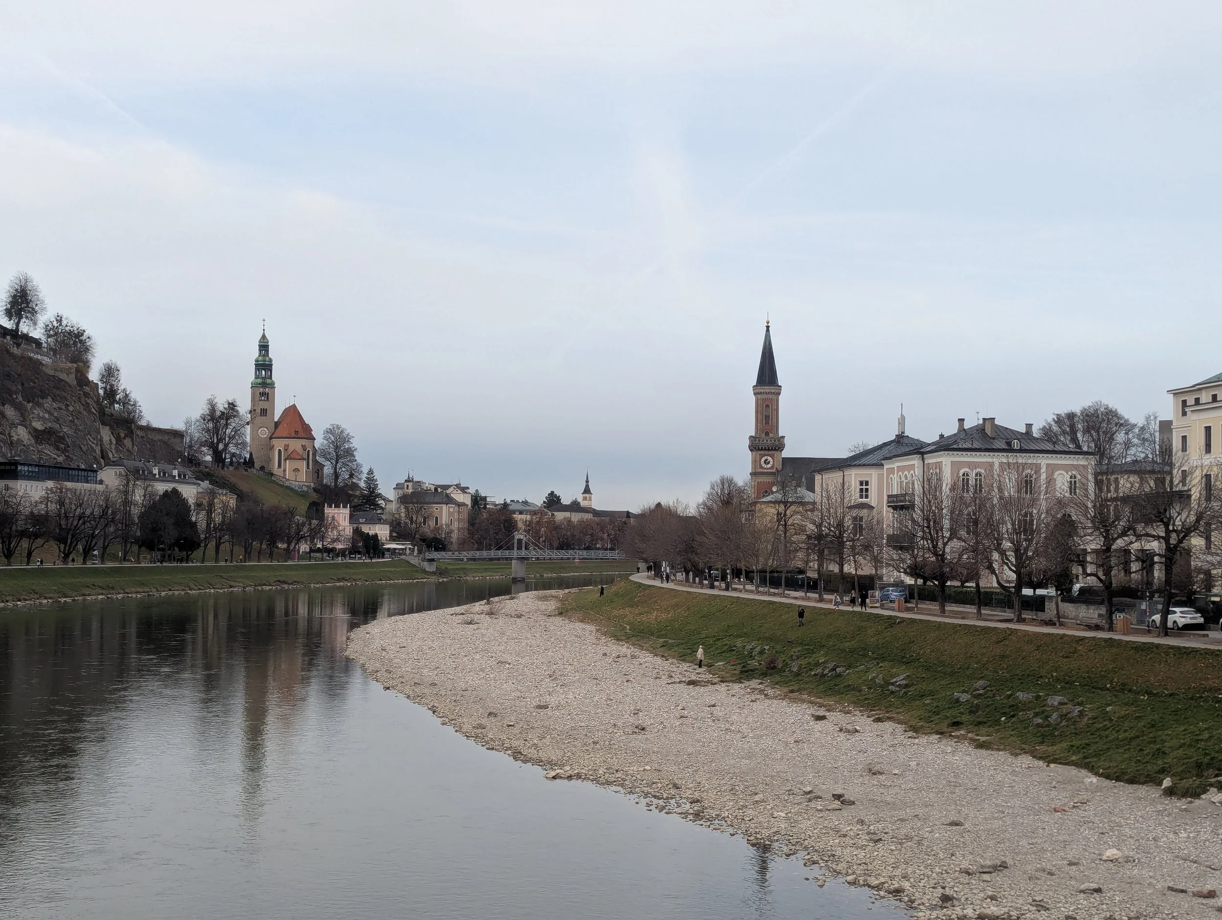 Sunrise Travel boutique river cruise shore excursion view of the Salzach River in Salzburg Austria featuring historic steeples and city architecture.