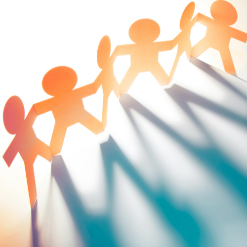 Paper cutout figures holding hands in a chain with shadows on a bright background