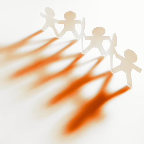 Paper cutout figures holding hands forming a chain, with shadow effects creating a visual pattern.