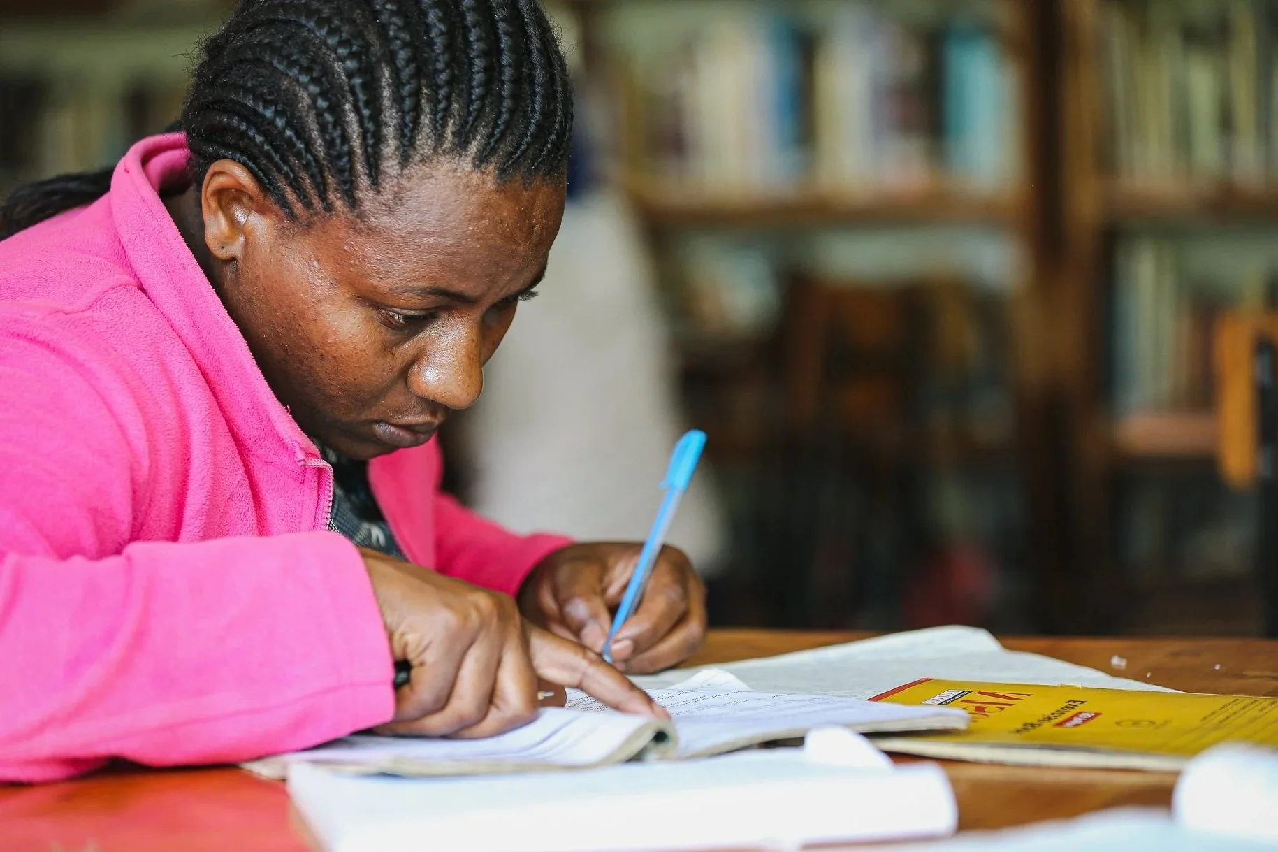 Woman writing on a notebook.
