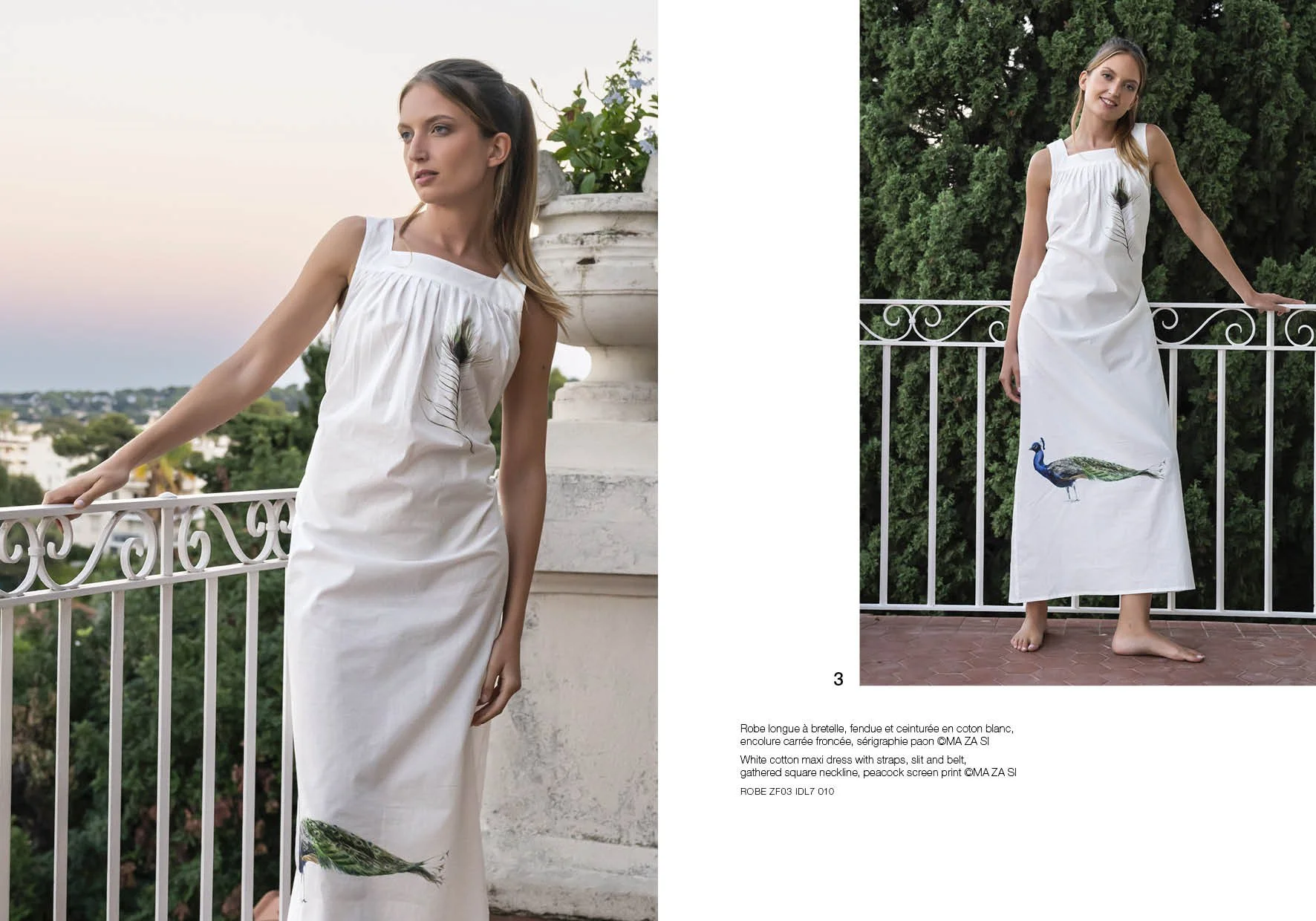 Une femme porte une longue robe blanche avec un motif de paon, se tenant sur un balcon entouré de verdure, lors du coucher de soleil.