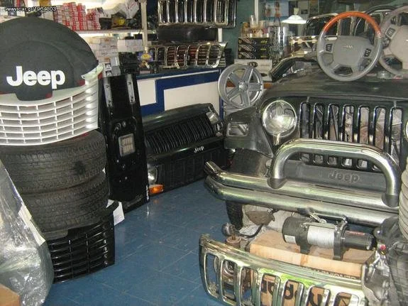 Interior of an auto parts store with Jeep vehicle parts and tires on display.