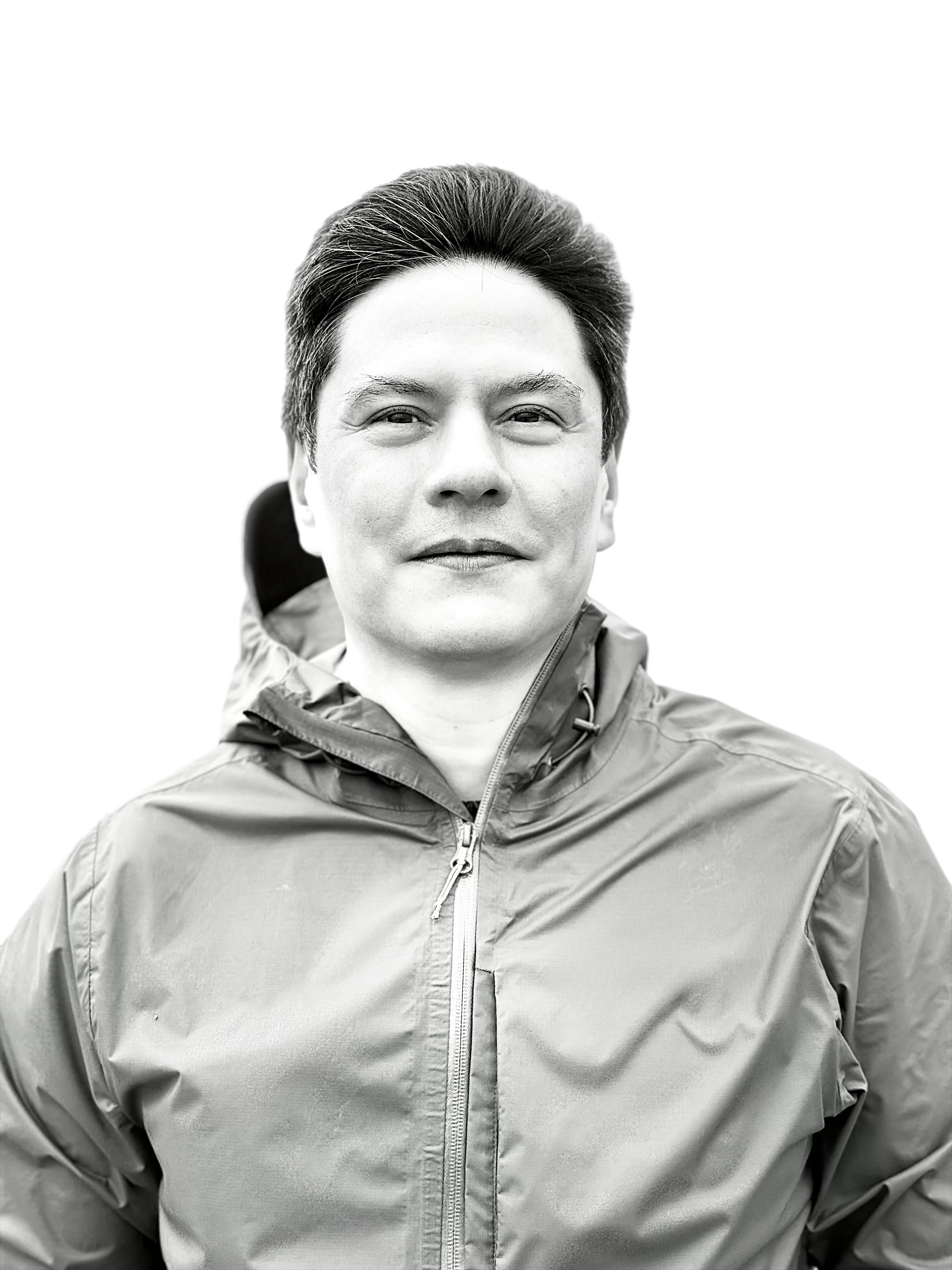 The author wearing a jacket, looking at the camera with a neutral expression, black and white photo.