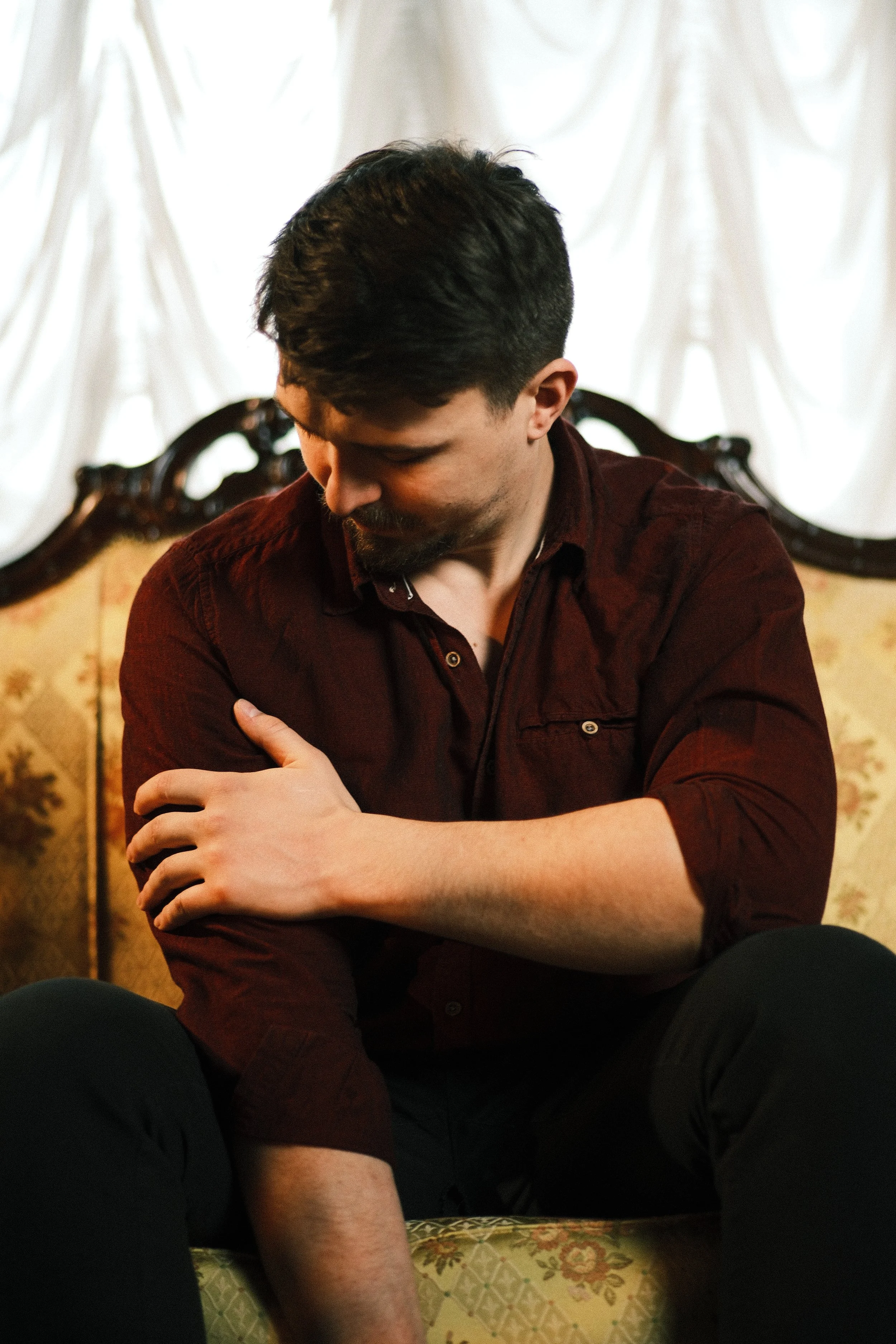 Man carresing himself on a sofa