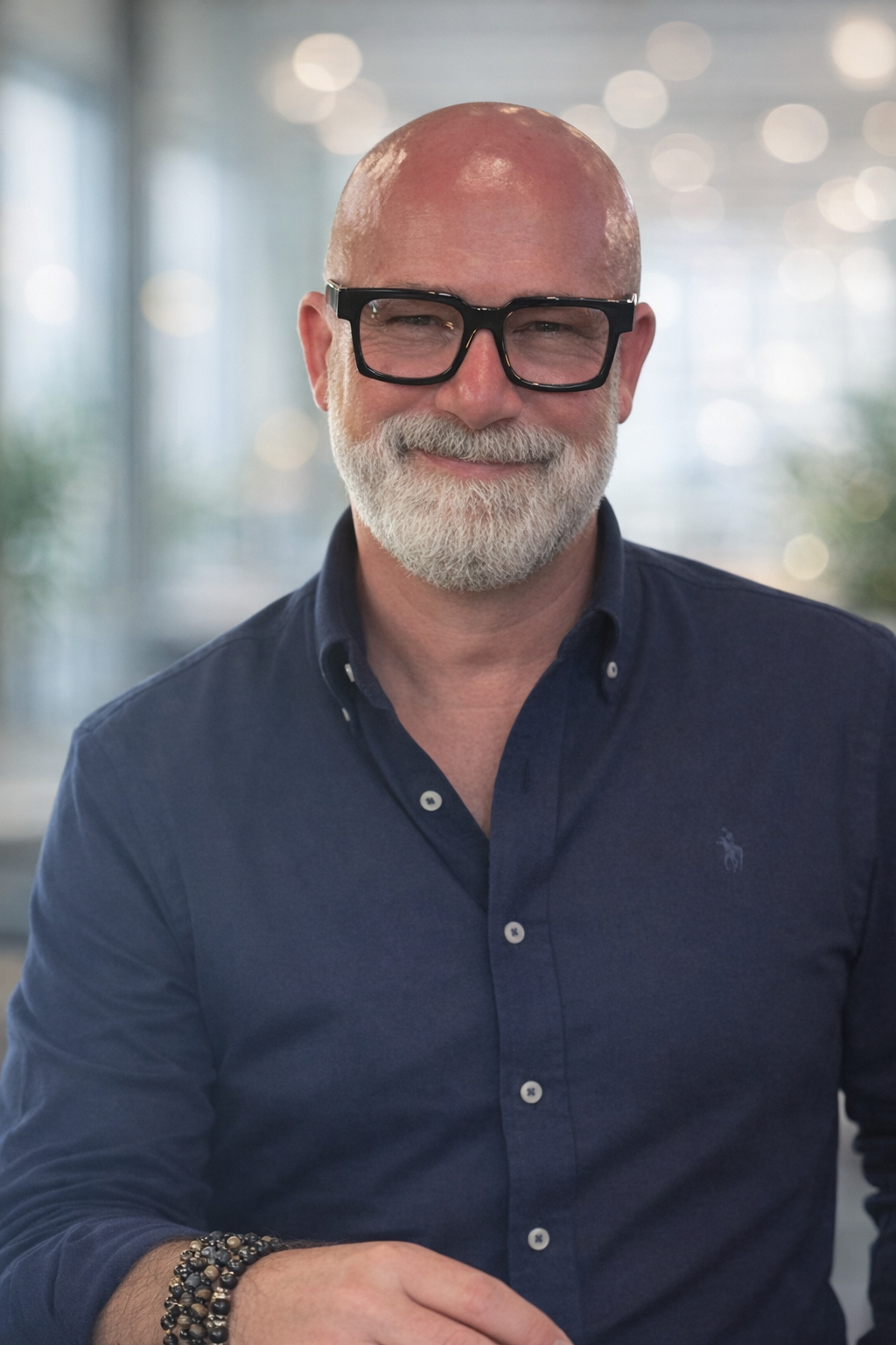 A gentleman with a beard wearing a blue shirt.  This is Kevin Wallace, Co-Founder and Non-Executive Director