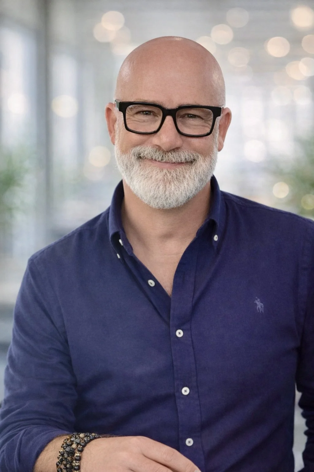 A gentleman with a beard wearing a blue shirt. This is Kevin Wallace, Co-Founder and Non-Executive Director