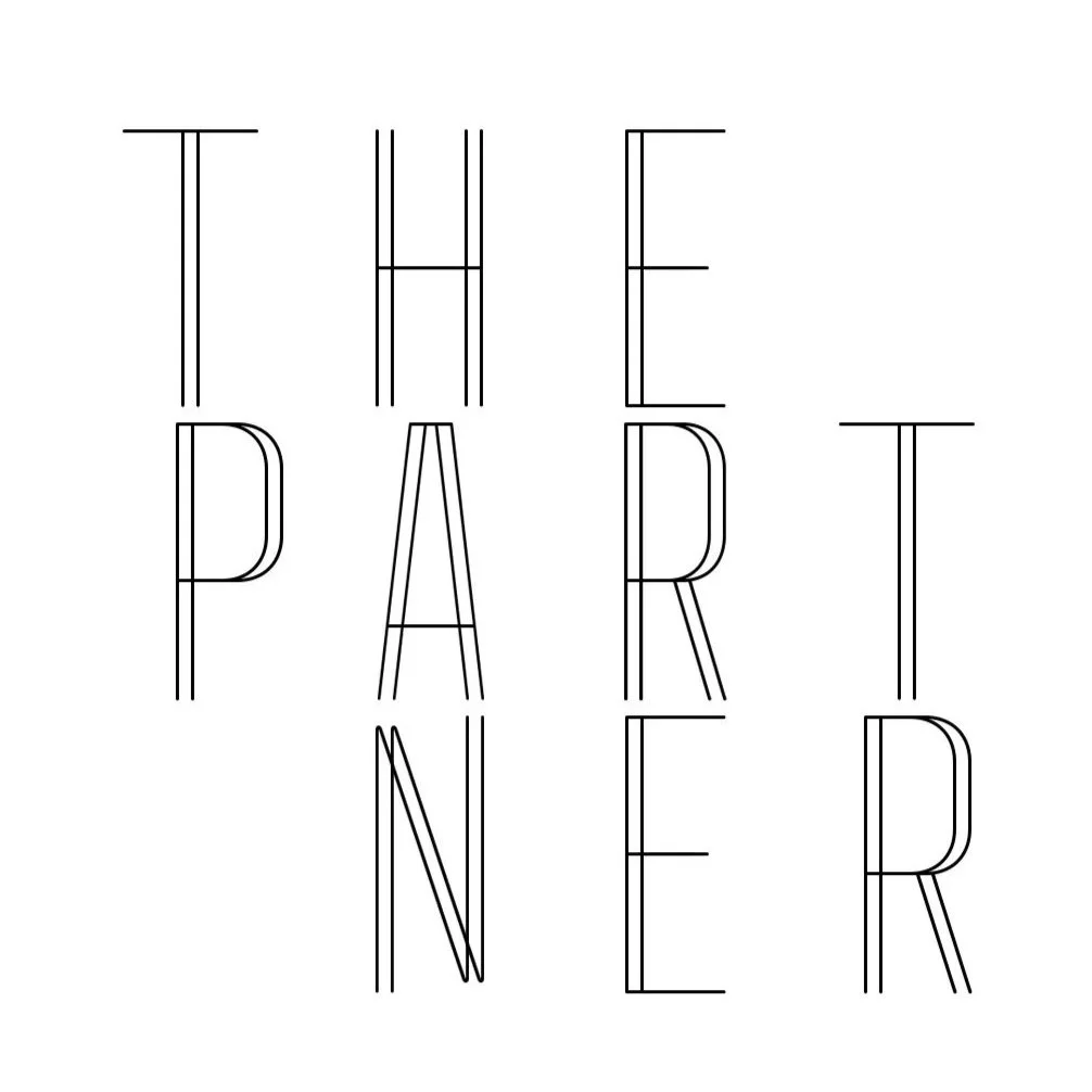 Text in the image that reads 'THE PARENT' in large, thin letters, with a sleek, elegant design, on a white background.