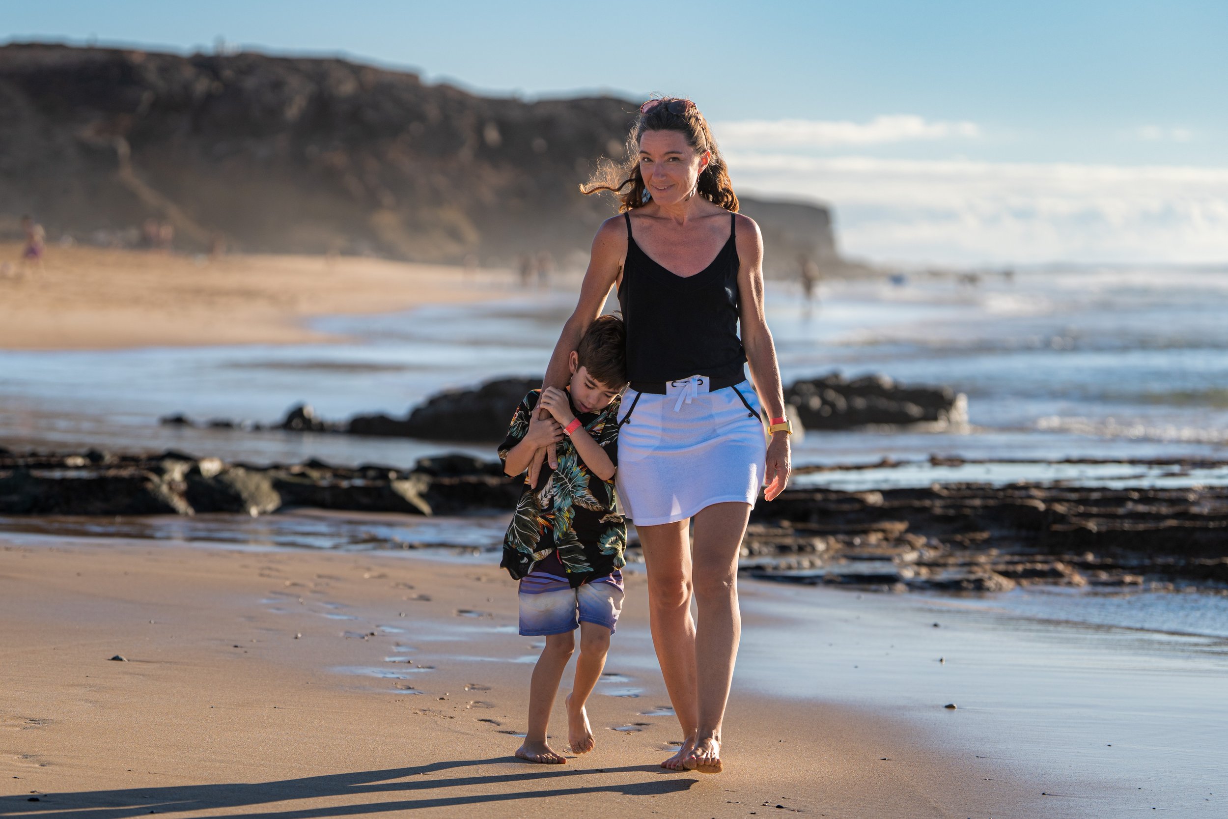 Mère et enfant en promenade complice sur la plage