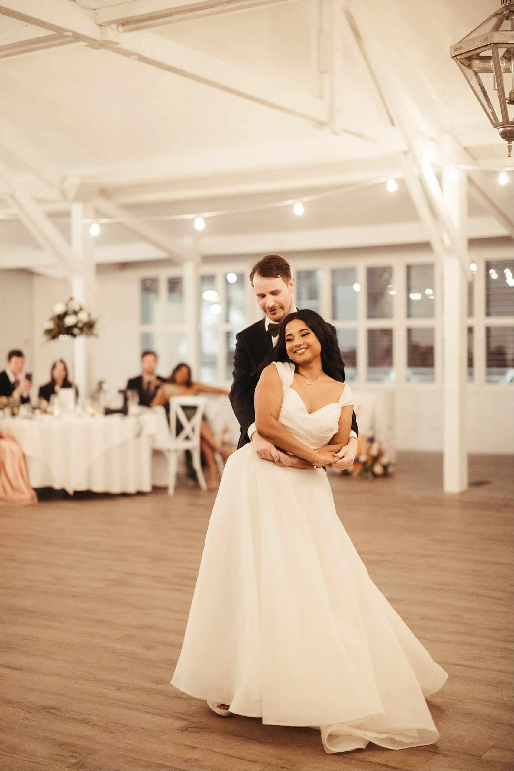 A bride and groom enjoying their first dance.