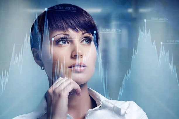 A woman with short dark hair looking thoughtfully, with financial graphs overlayed in digital style around her.
