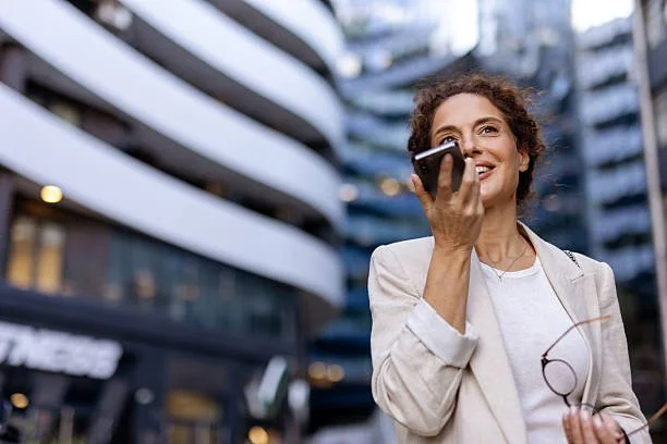 A woman giving a presentation to a group of five professionals in an office conference room.