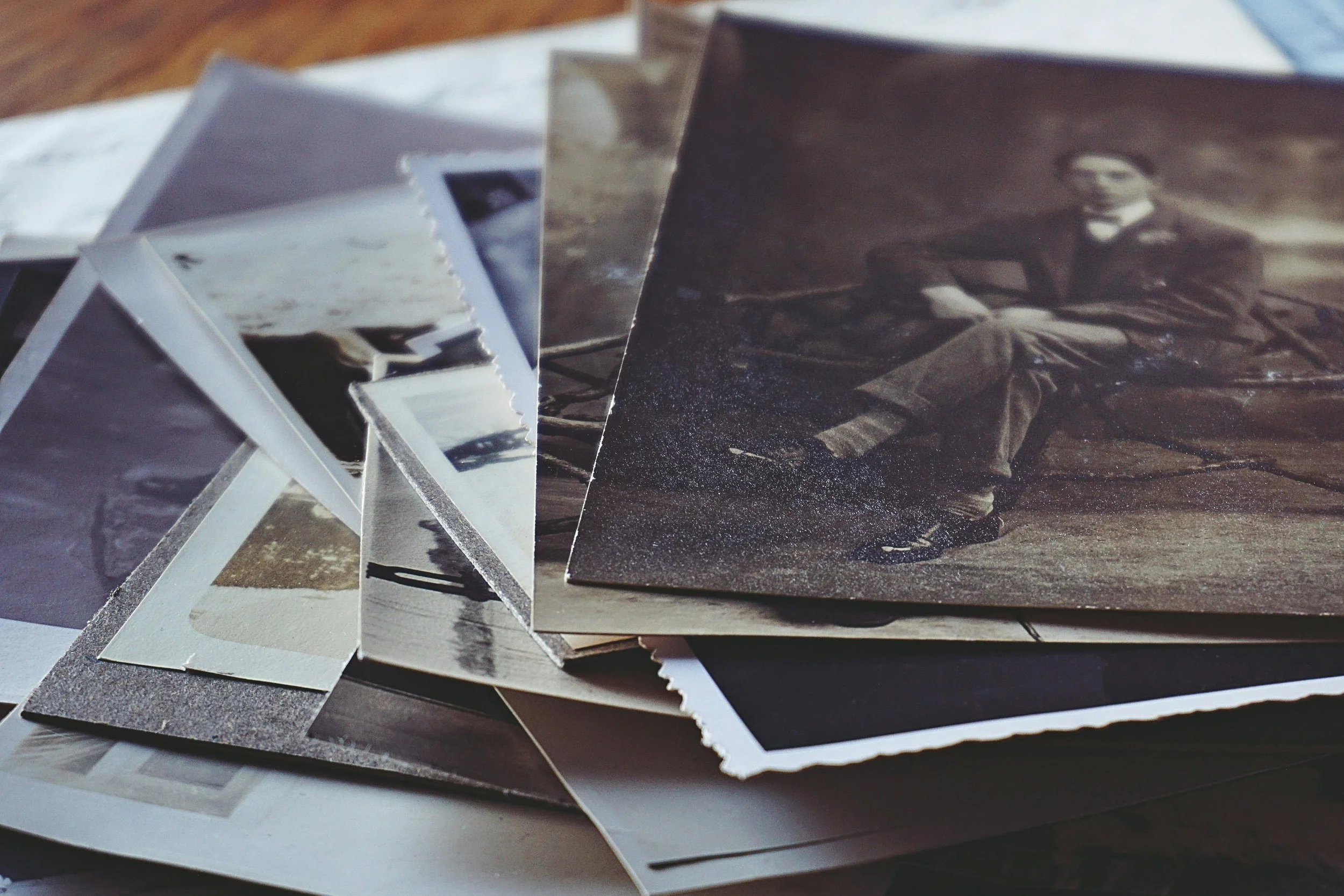 A stack of vintage black and white photographs