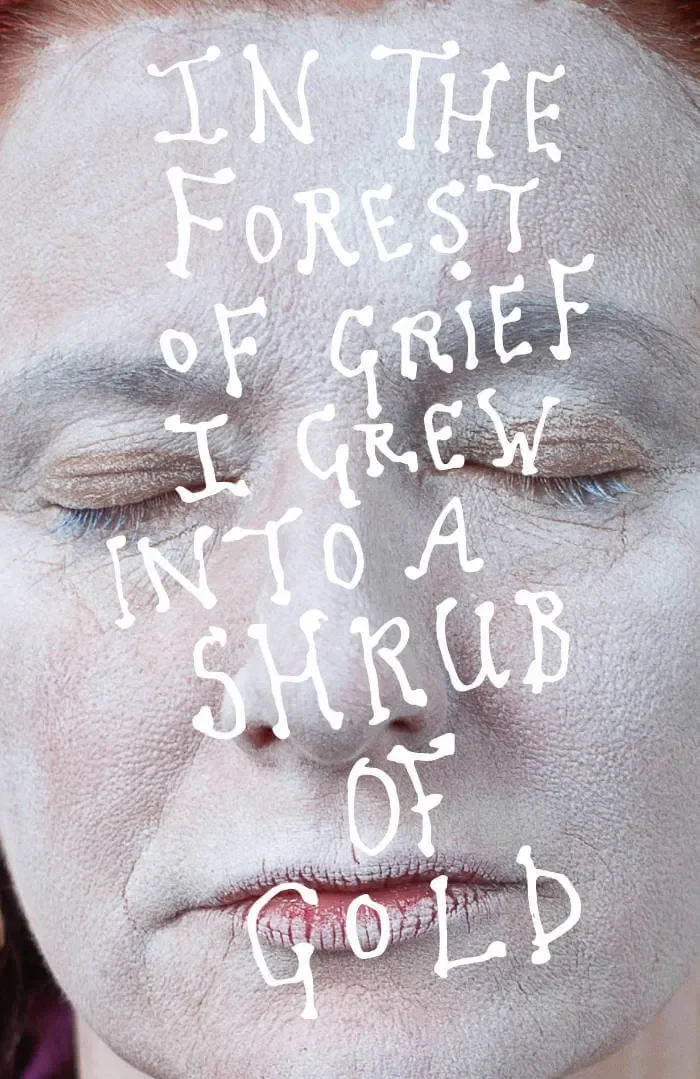 Close-up of a person's face with closed eyes and pale makeup, with the words "In the forest of grief I grew into a shrub of gold" written over the face.