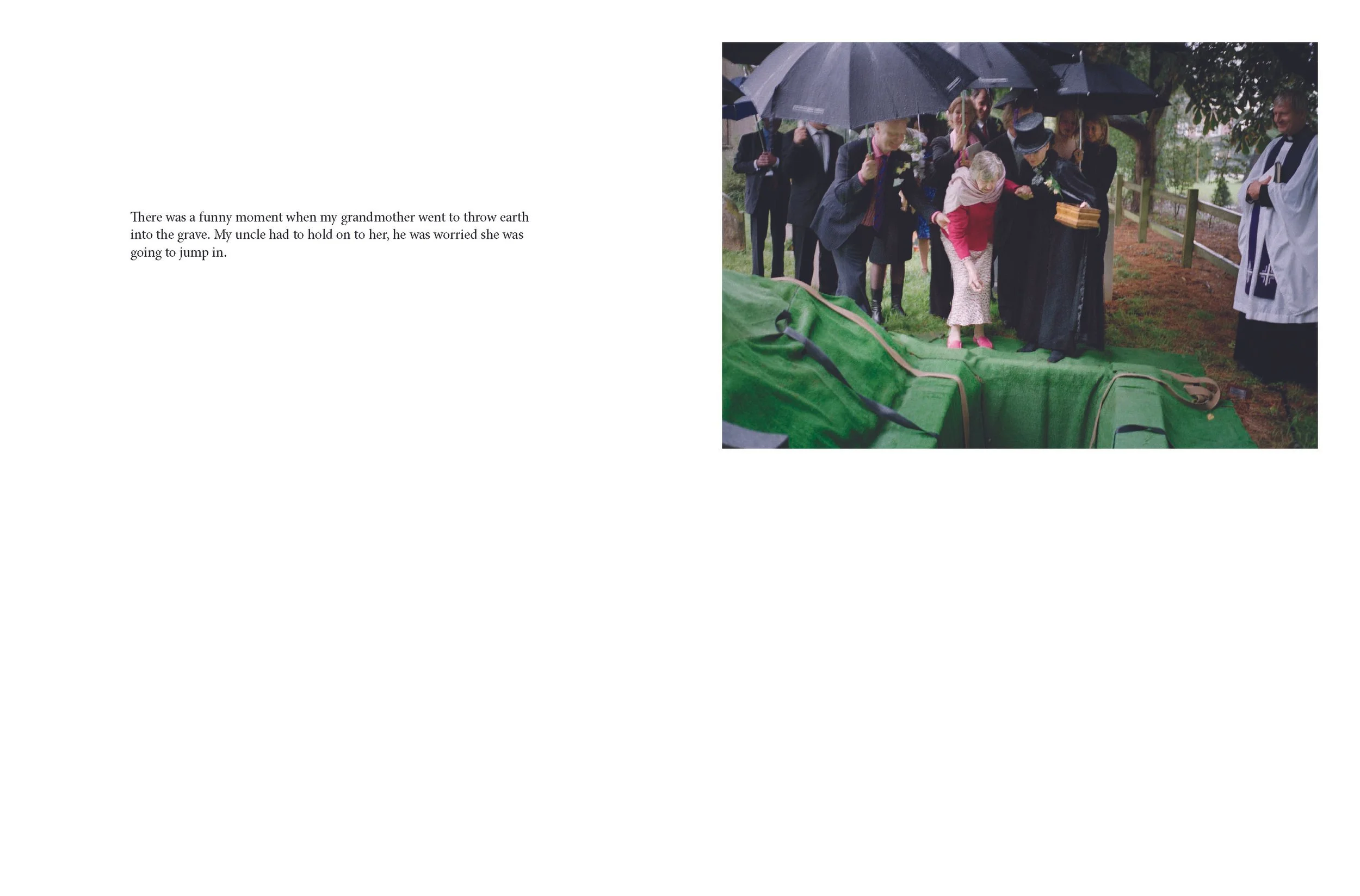 A group of people holding umbrellas gather around a woman who is leaning over a green casket outdoors on a rainy day.