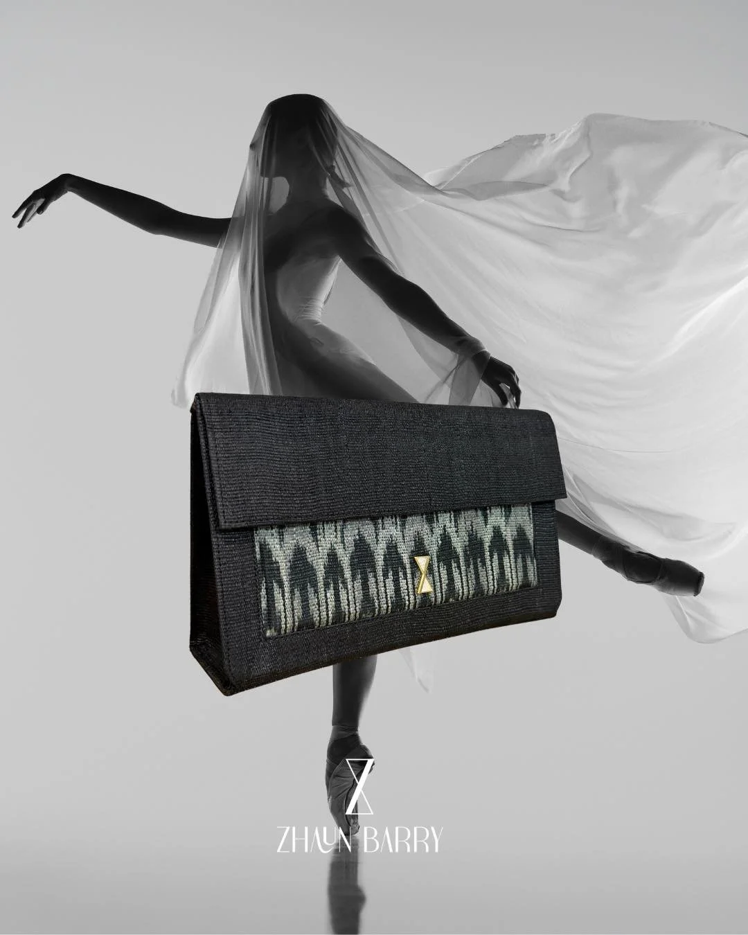 Black and white fashion photograph of a ballet dancer in a flowing dress, holding a designer clutch bag, with the name Zhong Barry at the bottom.