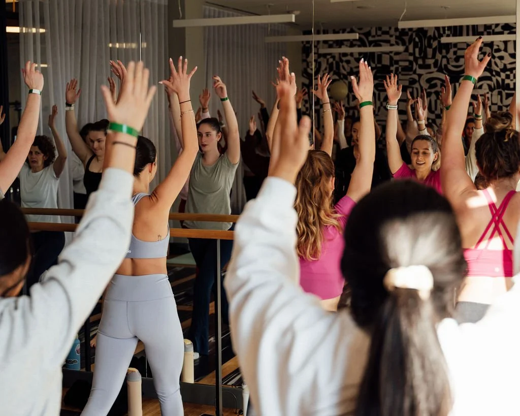 Group of participants moving together during a Su + Soul community pop-up