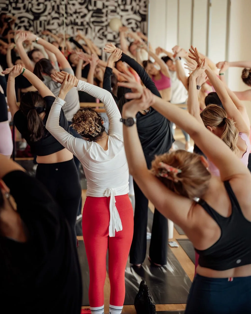 Guests flowing through a guided movement session in a bright studio.