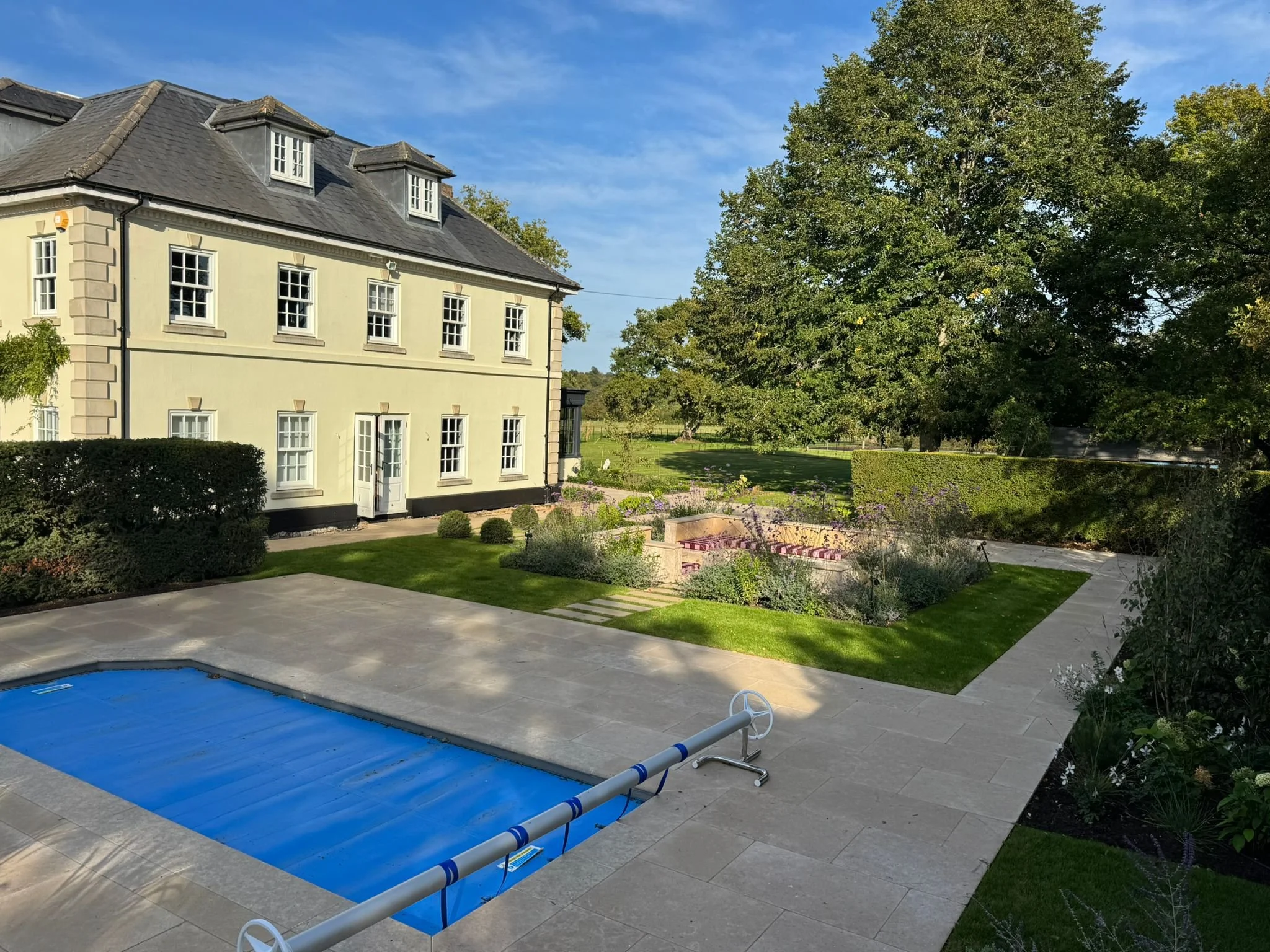 View from pool to seating area and rear aspect of property