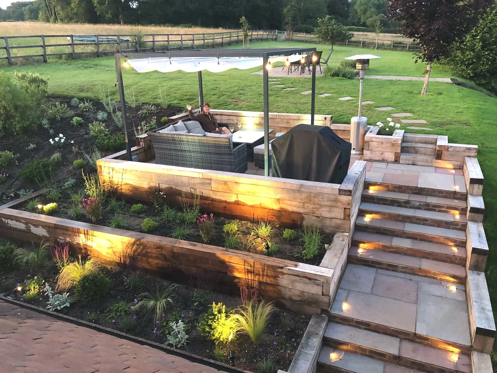 Newly-planted flower beds around raised terrace and steps area