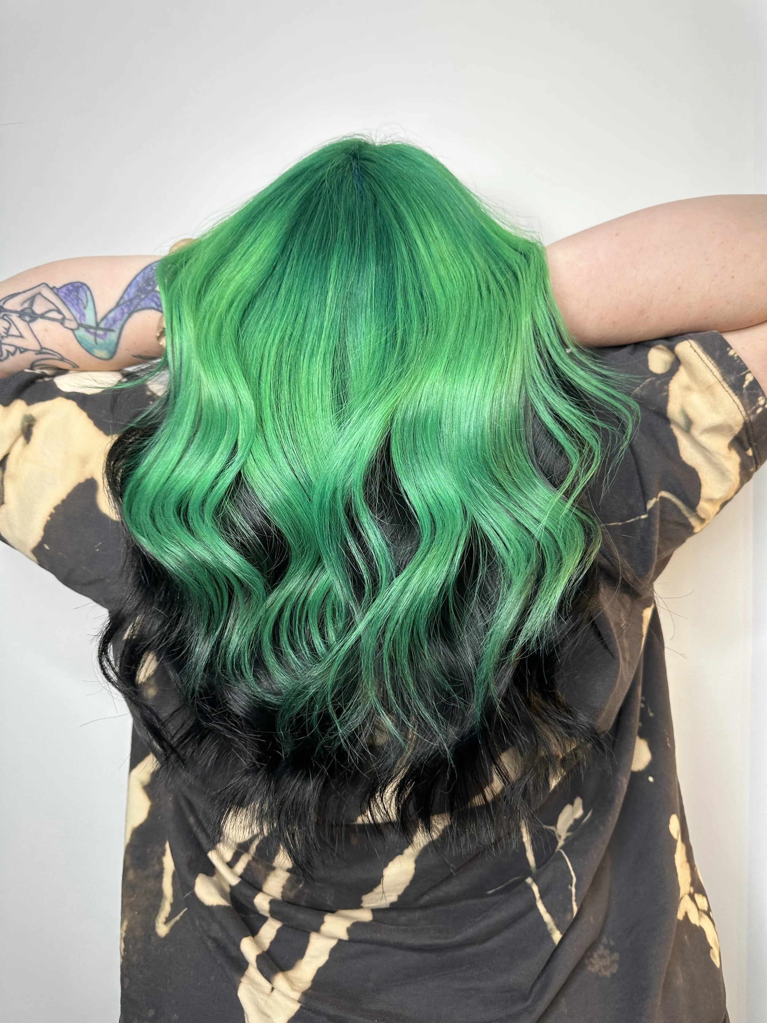 Bristol based hair stylist Ryan Hampson has done this hair colour, vivid green with black underneath.