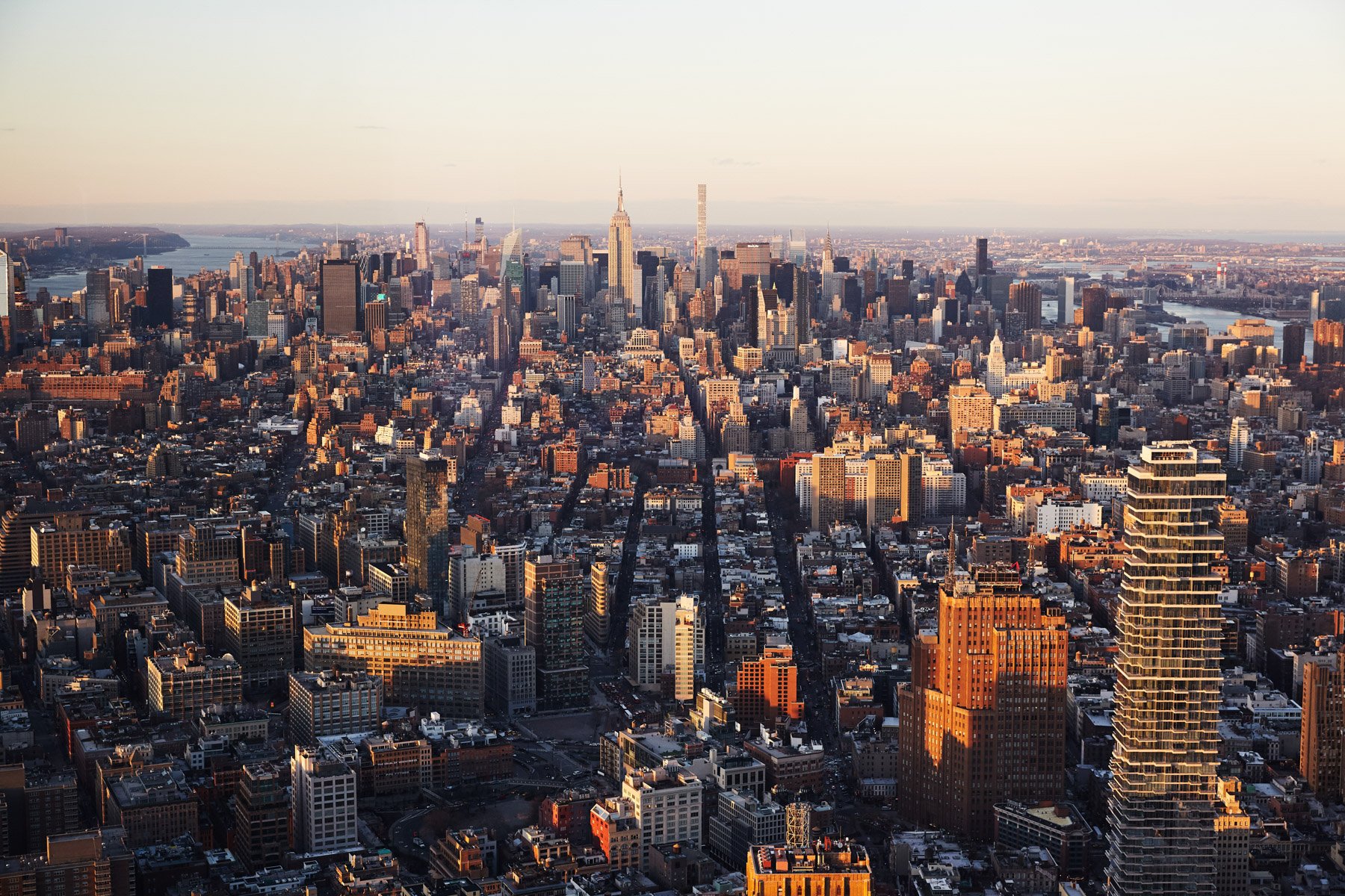 Aerial view of Manhattan skyline at sunset with skyscrapers and cityscape. New York City