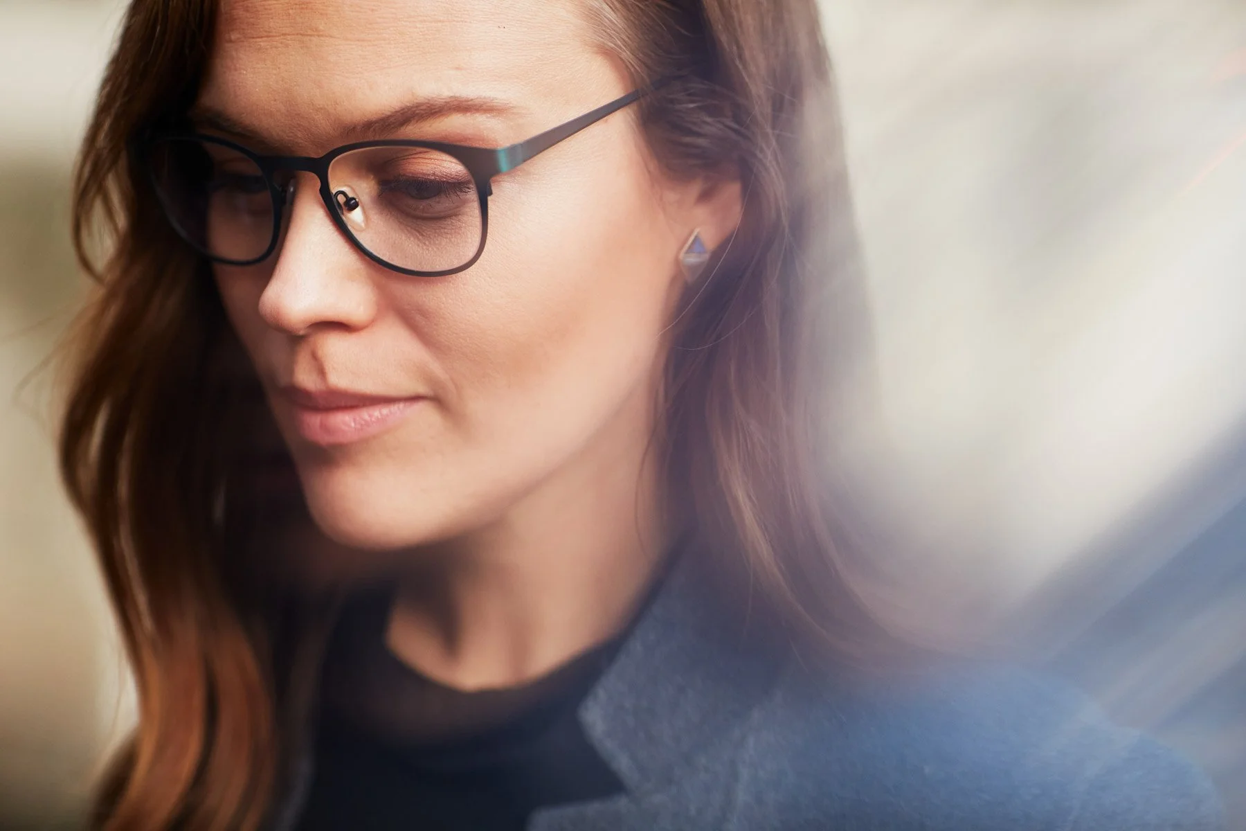 Woman with glasses wearing a blue blazer.