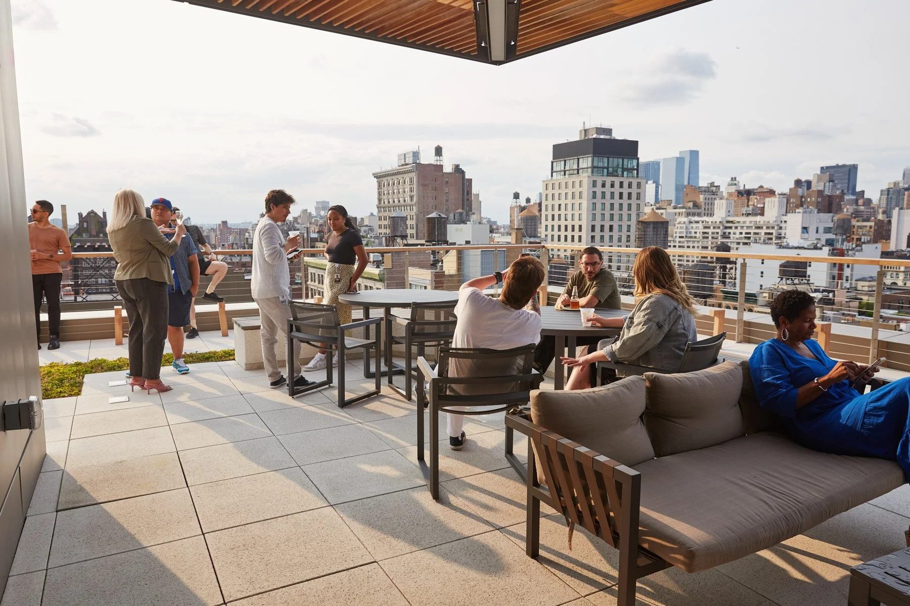 People socializing on a rooftop terrace with a city skyline view at Tidal headquarters in Manhattan New York City