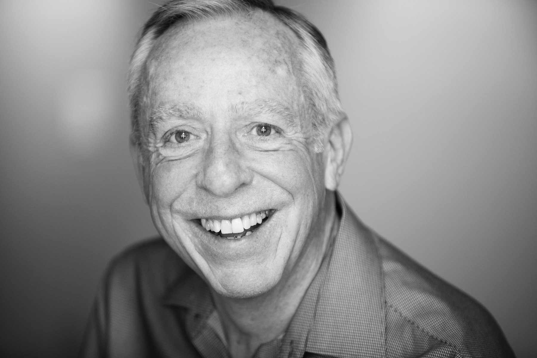 Smiling older man in black and white portrait for Wingman Advertising in Los Angeles California