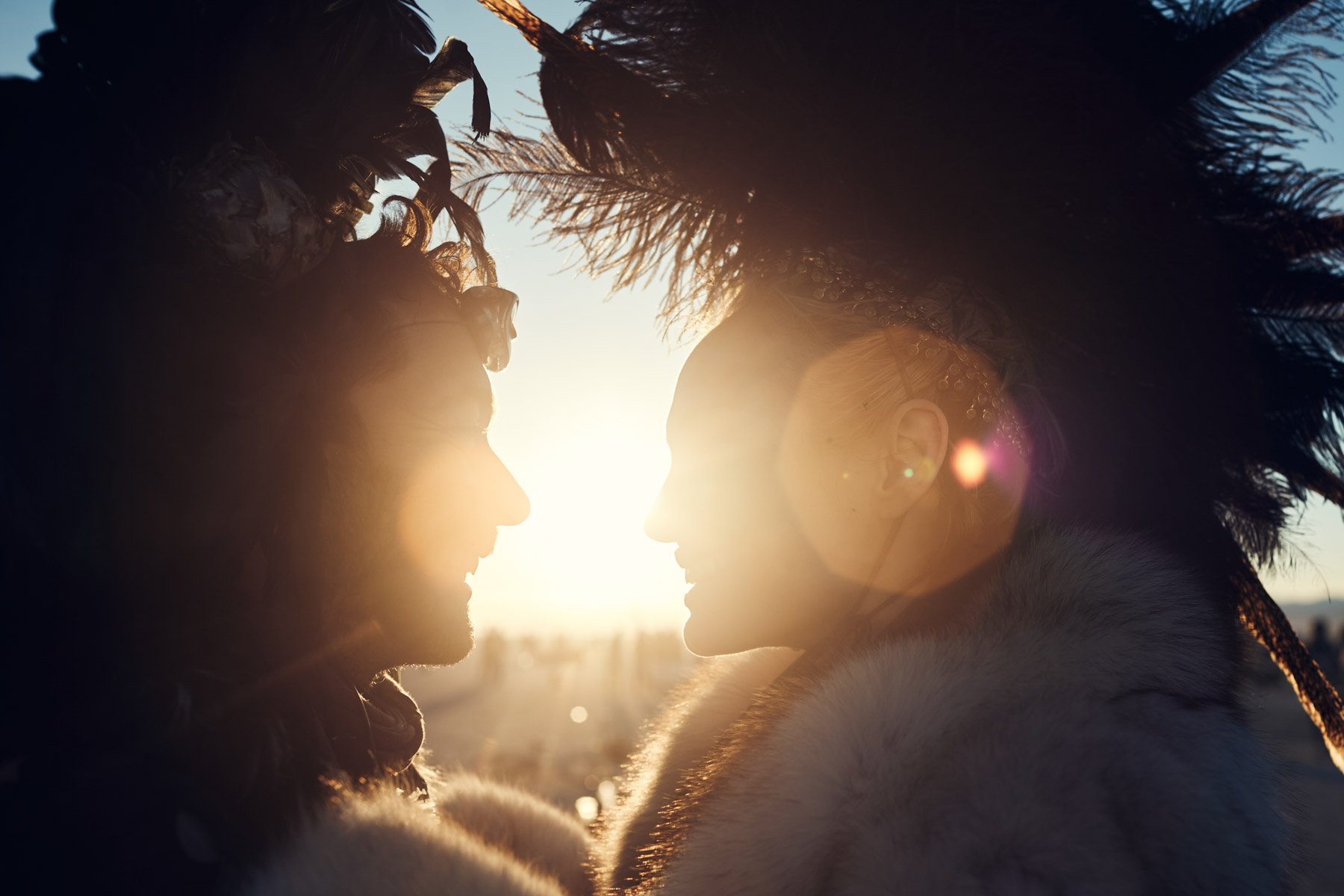 Burning Man 2015 Feather Headress Couple Kiss Sunrise Silhouette