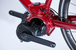 Close-up of an electric bicycle's crank area, showing the motor and pedal.