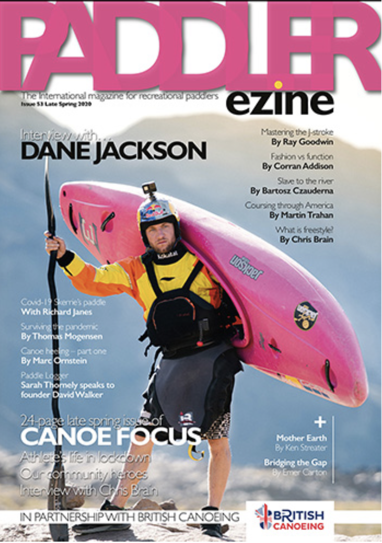 Cover of Paddler ezine, featuring a kayaker in a wetsuit and helmet holding a pink kayak on a beach.