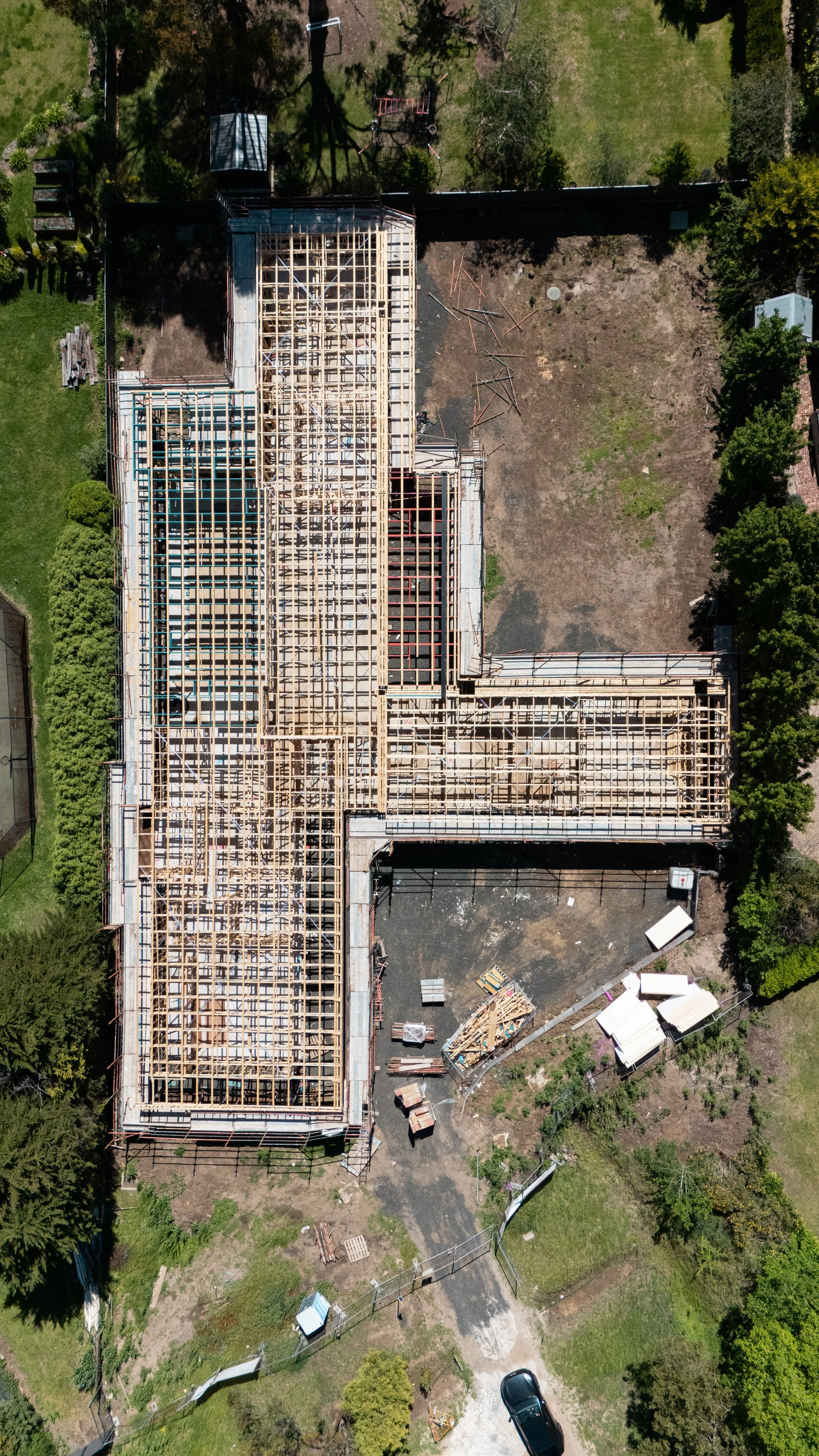 Aerial view of a building under construction with a wooden framework