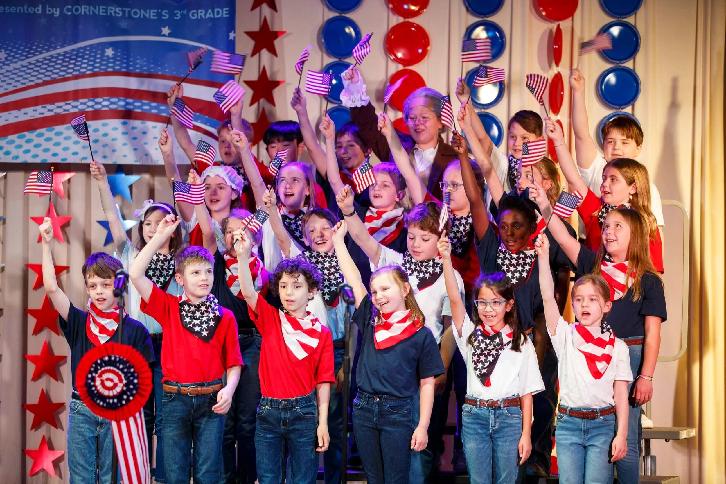 Private christian school students perform a patriotic performance waving American flags in Peachtree Corners