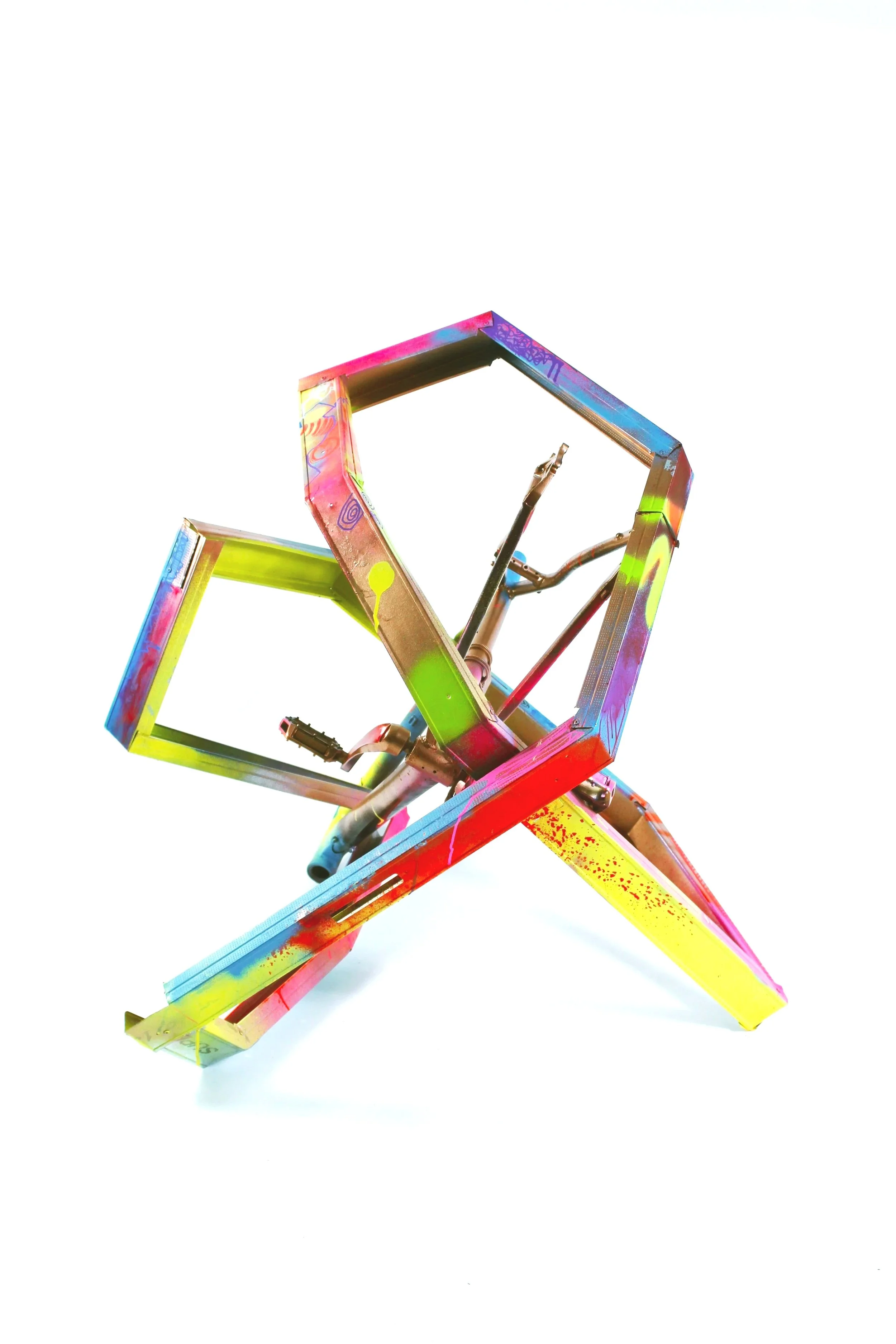 A colorful, abstract sculpture of a star with vibrant splashes of paint, set against a white background.