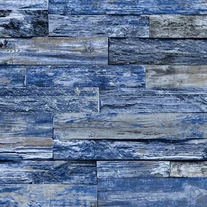 Close-up of a blue-toned brick wall with weathered textures.