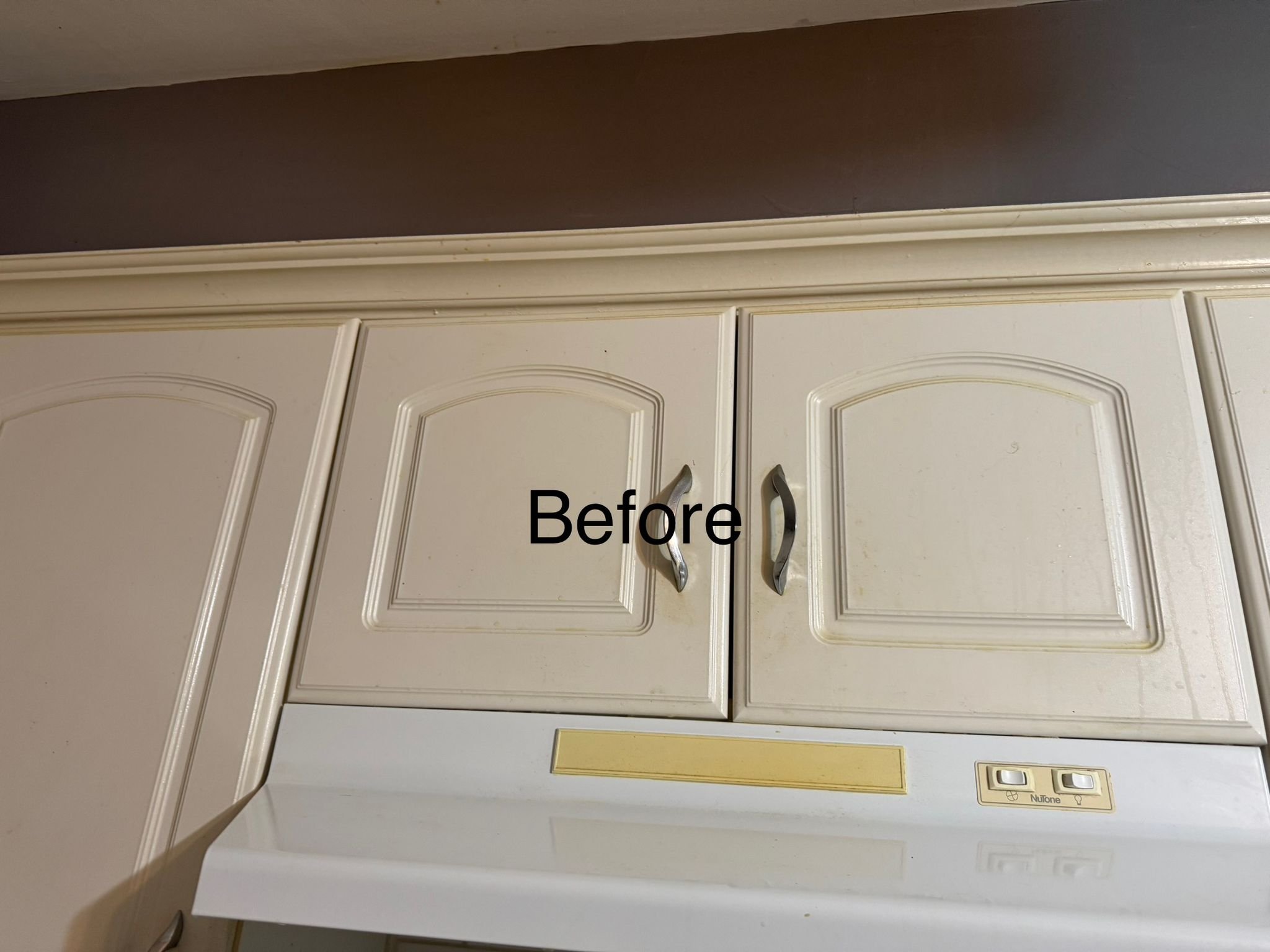 Kitchen cabinets with a label 'Before' written across the middle