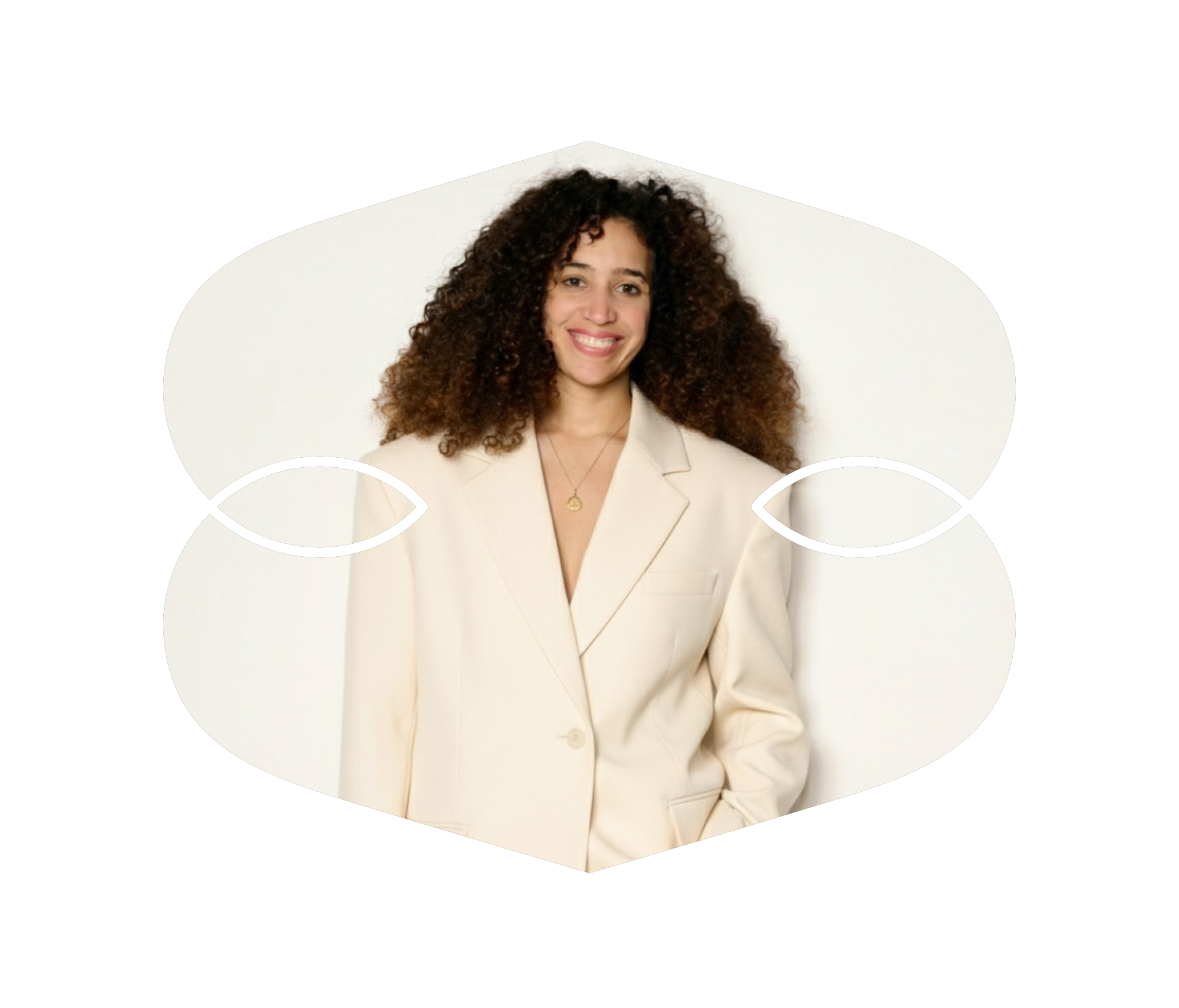 Marie Guérin, une femme souriante avec des cheveux bouclés portant un blazer blanc, posant contre un fond blanc.