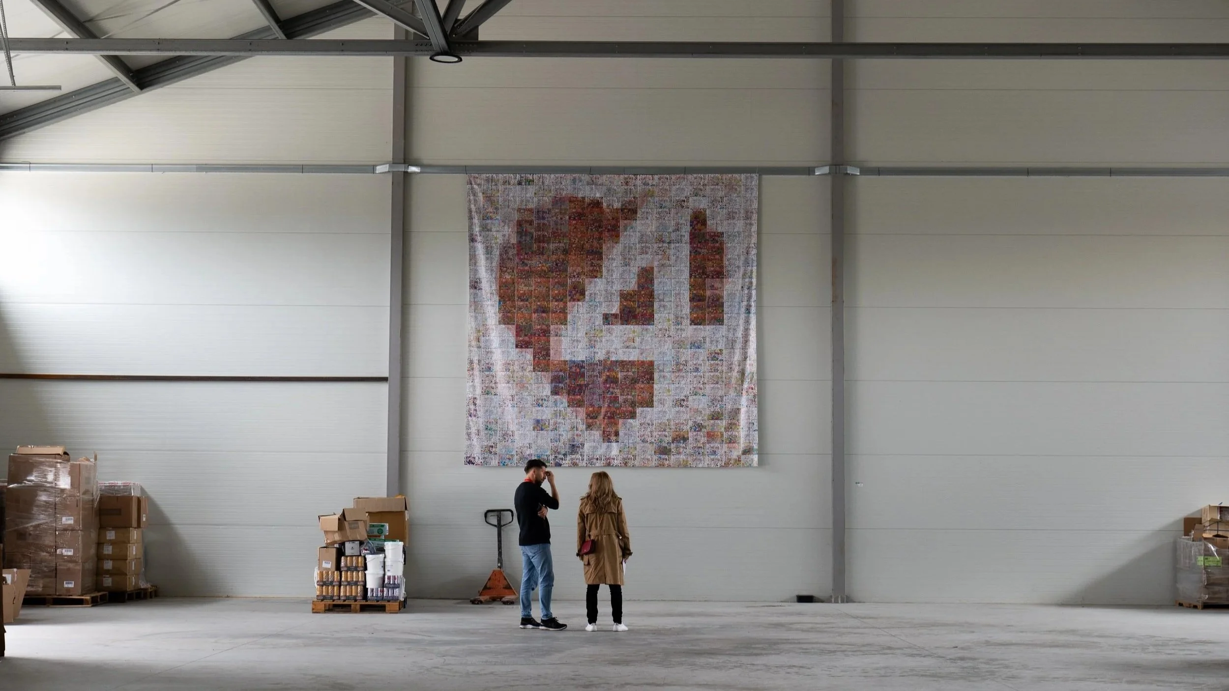 Two people in warehouse Hope4 banner above by Joe Beynon Media