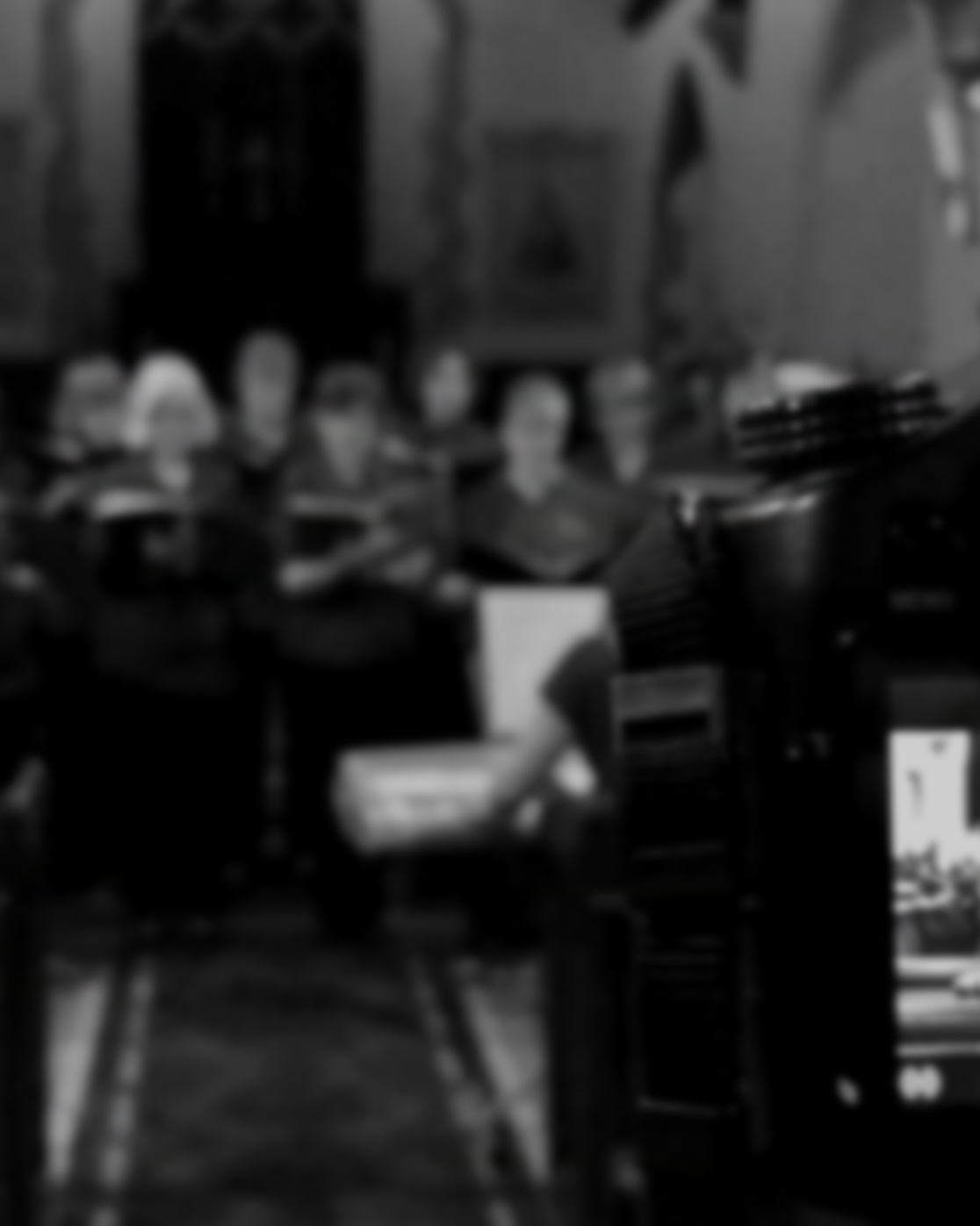 Behind the scenes a black and white photo of a female choir. Joe Beynon Media