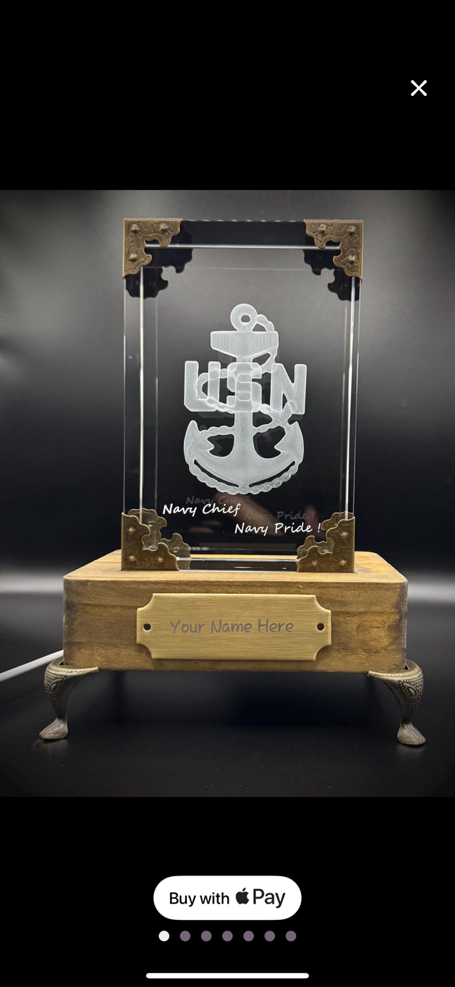 A decorative plaque with a Navy theme, featuring an anchor and the words "Navy Chief Navy Pride!" on a clear acrylic panel. The plaque is mounted on a wooden base with a customizable nameplate reading "Your Name Here". The frame has ornate metal corn